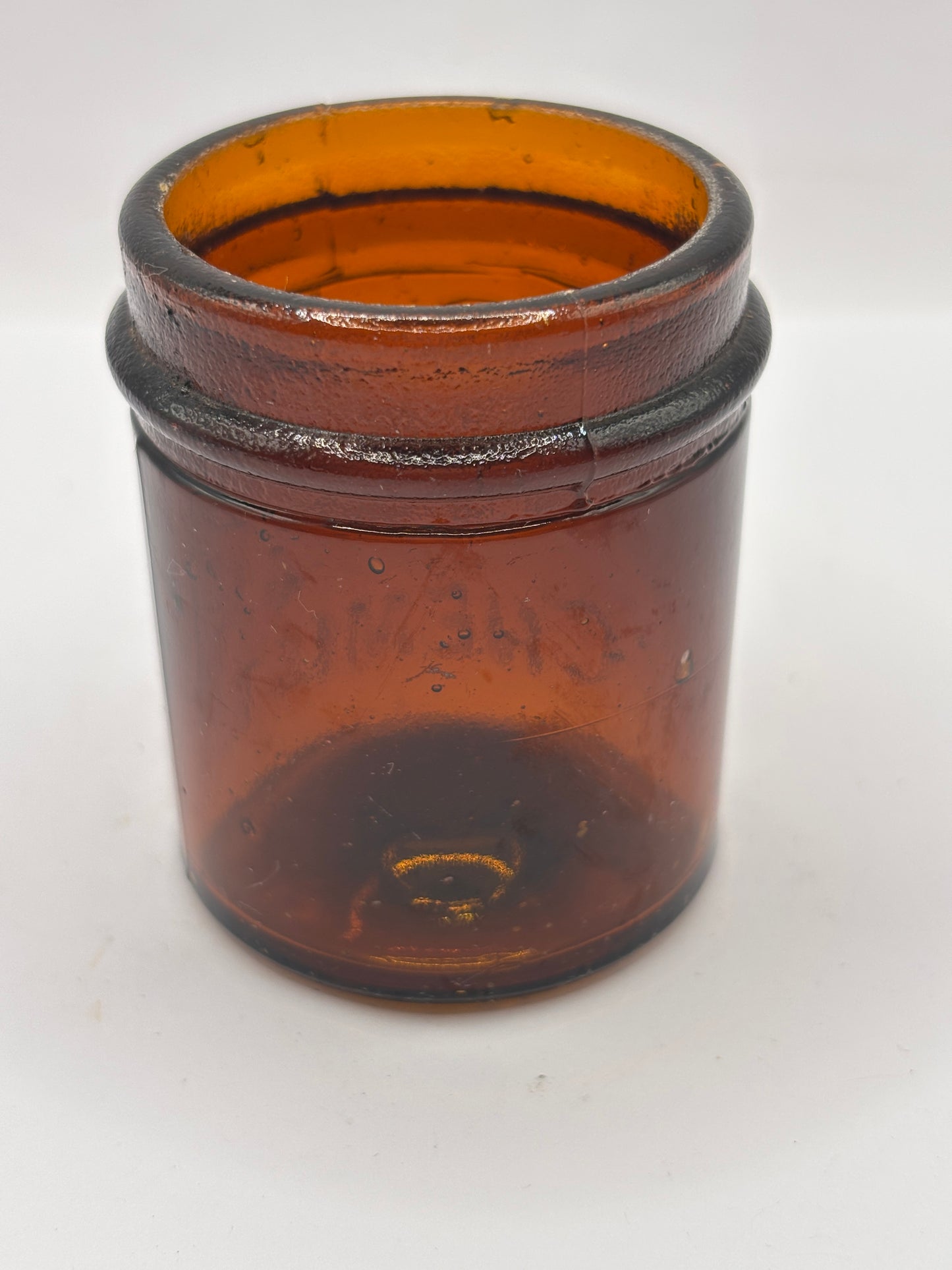 Small old amber glass boots jar
