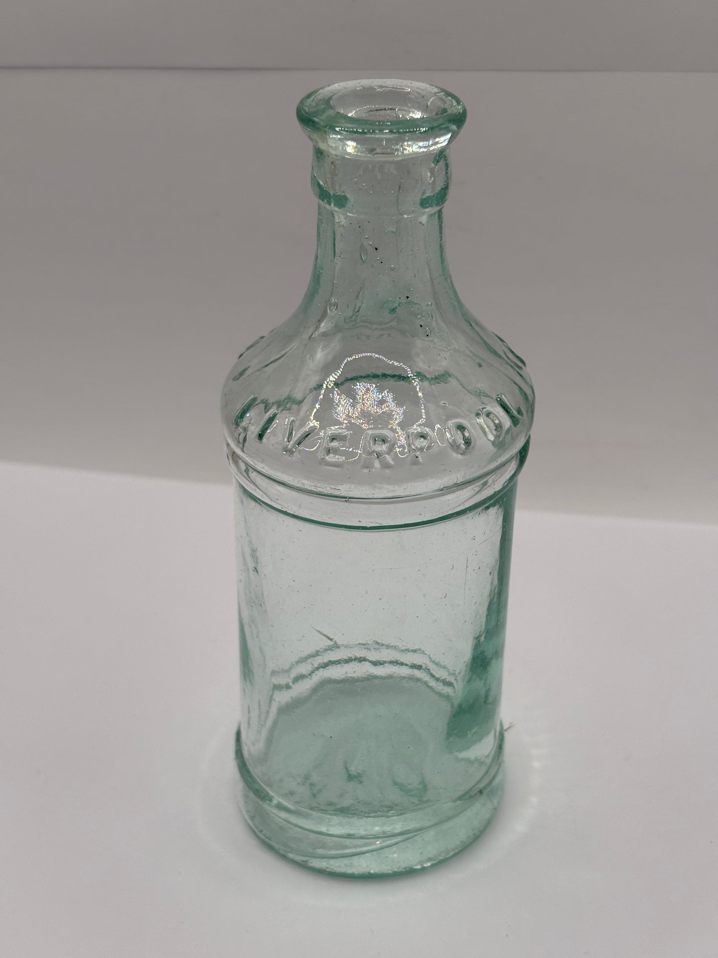 Old tall aqua glass pouring ink. Cochrans liverpool, ink bottle