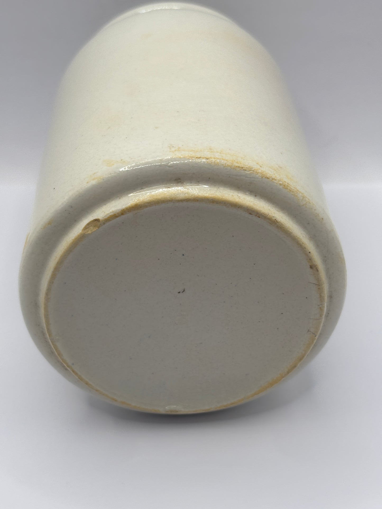 Old tall white rolled top stoneware jar