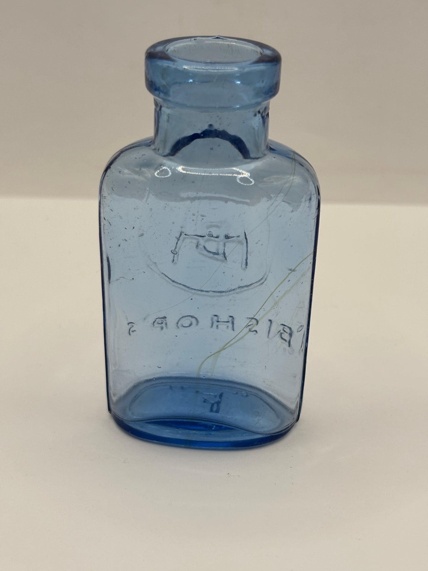 Old small blue glass advertising chemist bottle, Bishop