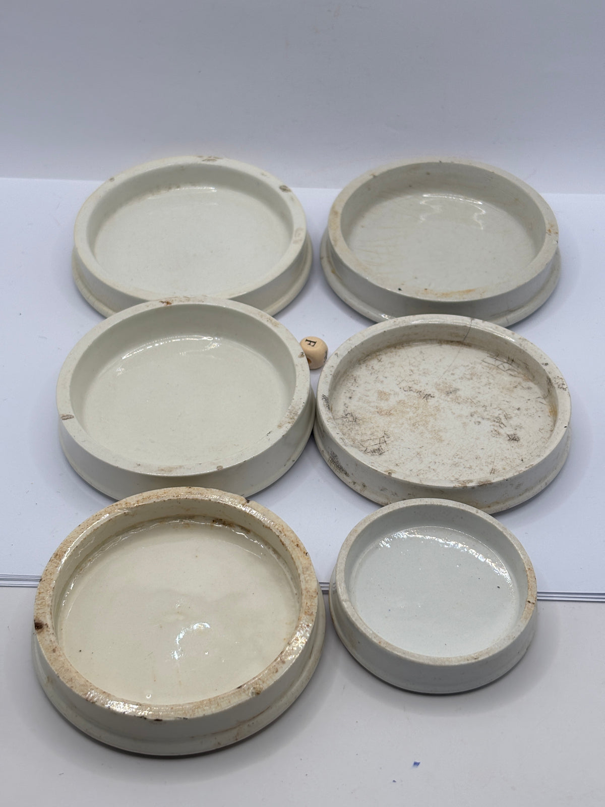 6 old stoneware lids, stackers (F)