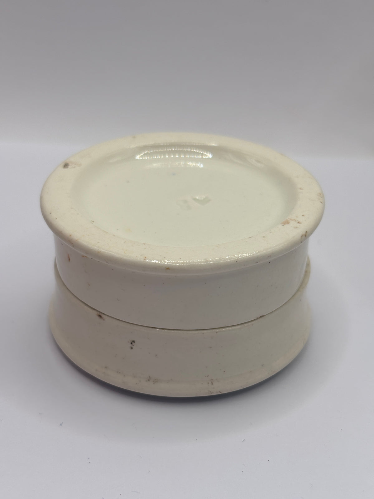 Old advertising lid and base. Woods areca nut tooth paste. Damaged