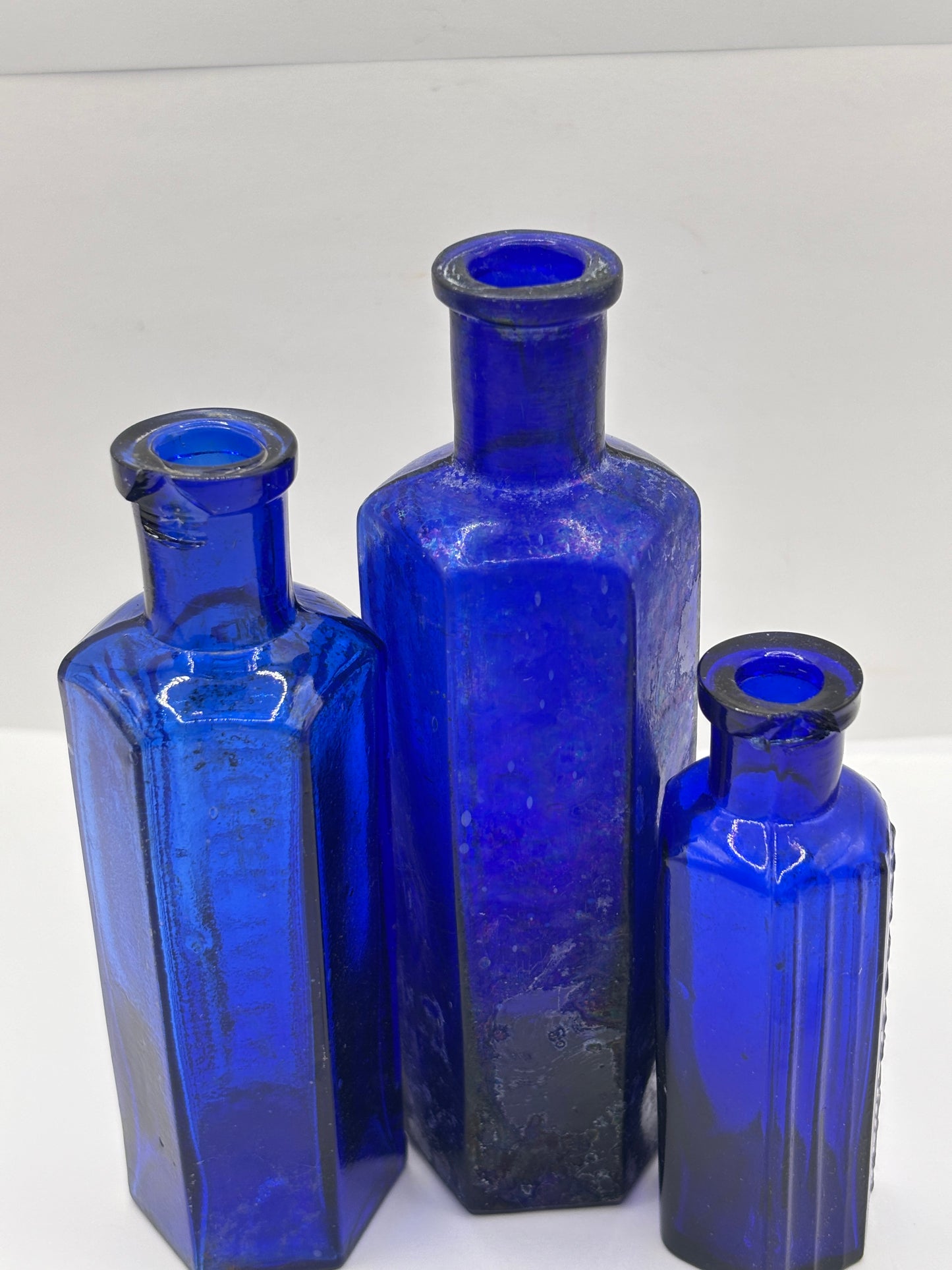 3 old blue glass poison bottles, chipped & crusty (a)