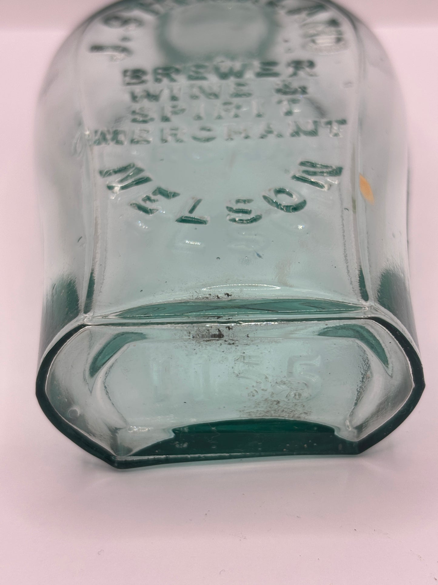 Old glass spirit flask, J.Strickland brewer wine & spirit merchant. Nelson