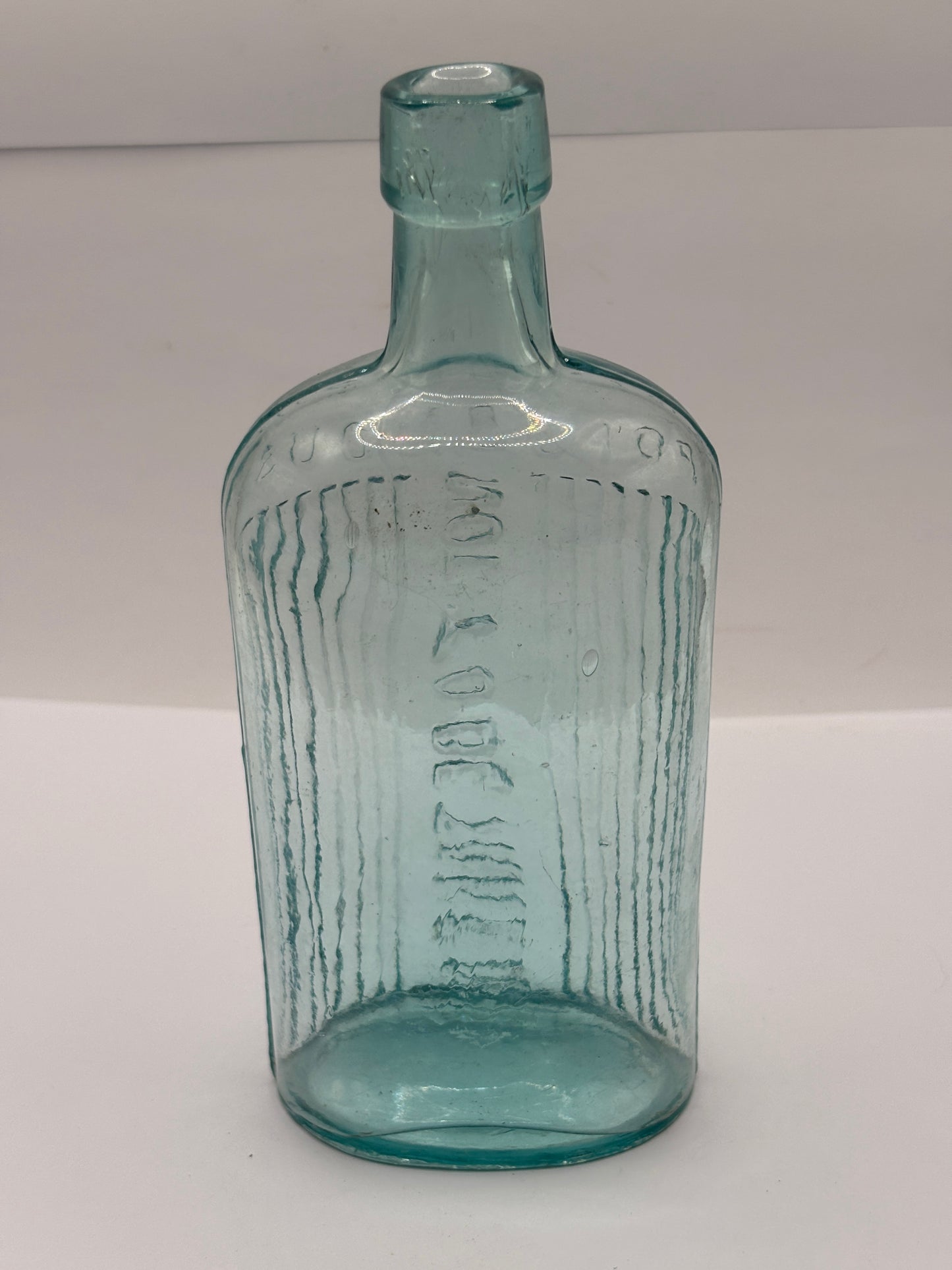 Old aqua glass poison bottle, not to be taken
