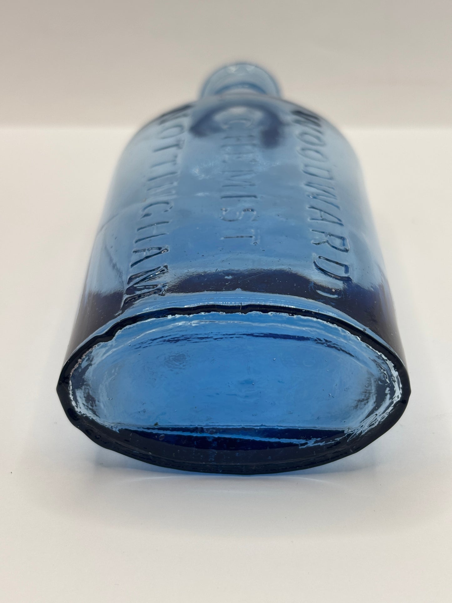 Old blue glass advertising chemist bottle, Woodwards Nottingham