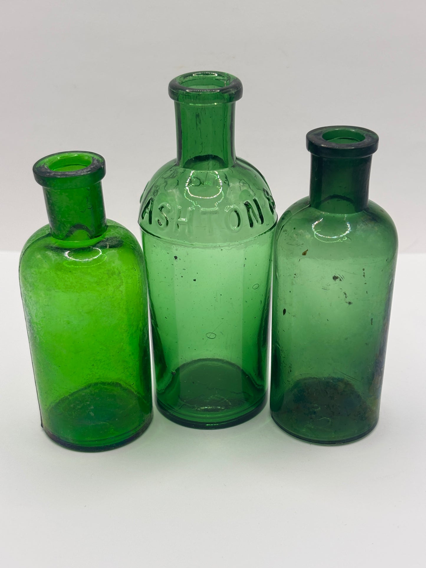 3 old green glass bottles