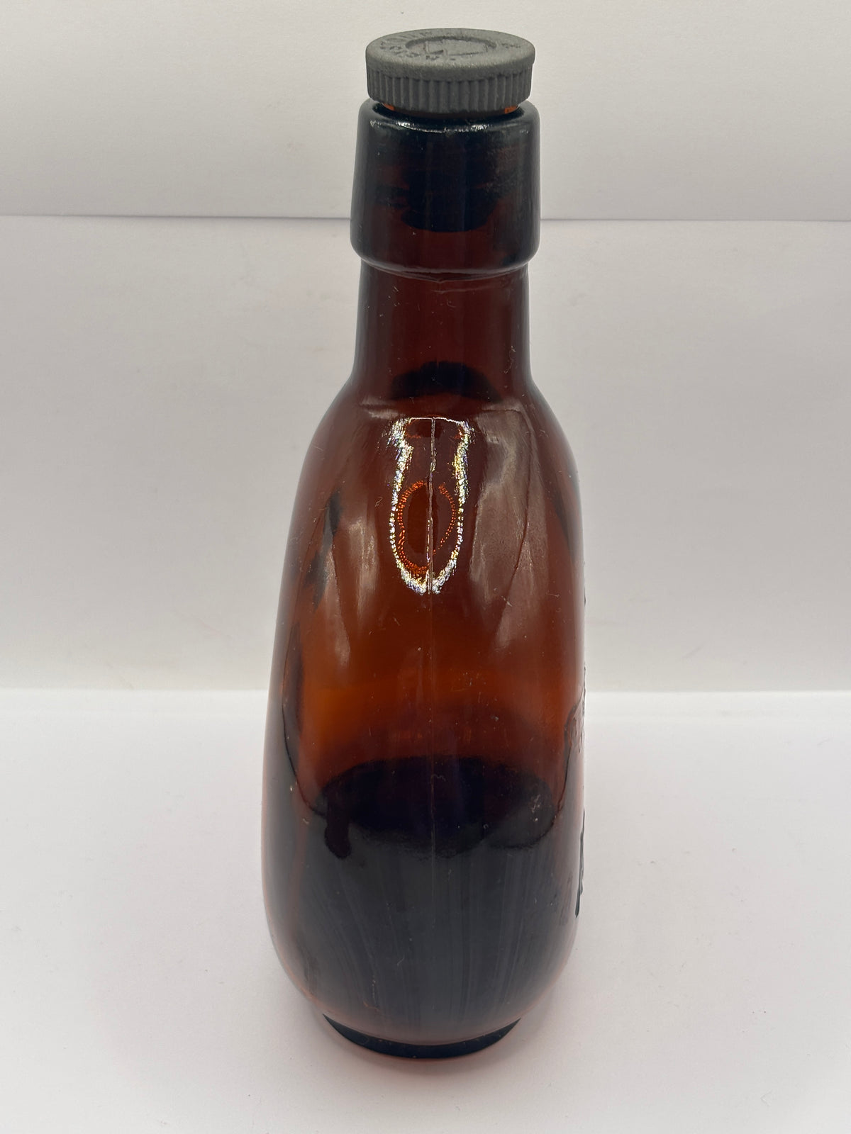 Old amber glass bottle with original stopper