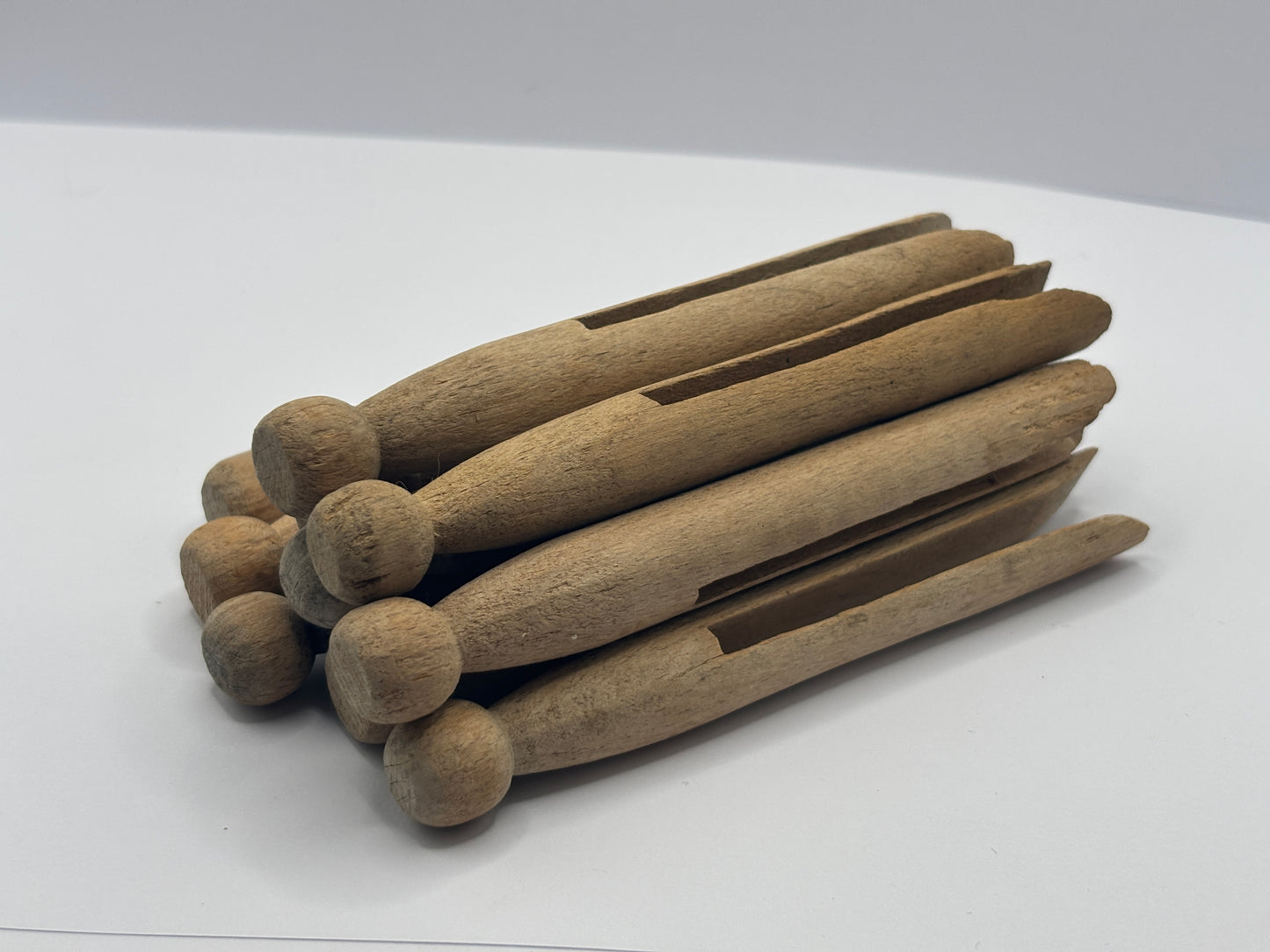 10 old wooden dolly pegs