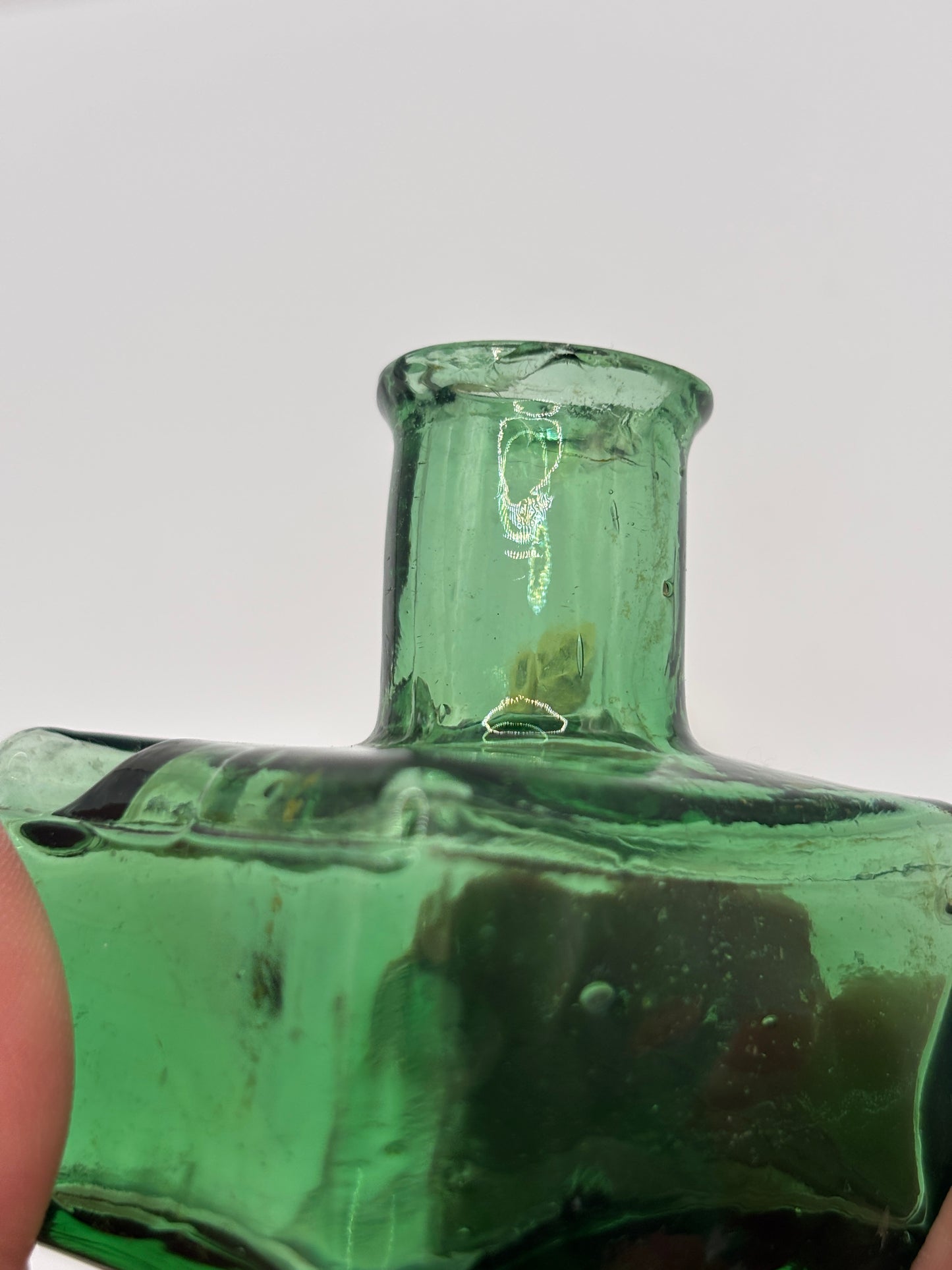 Old green glass ink bottle, inkwell. With pen rest (BH) chipped