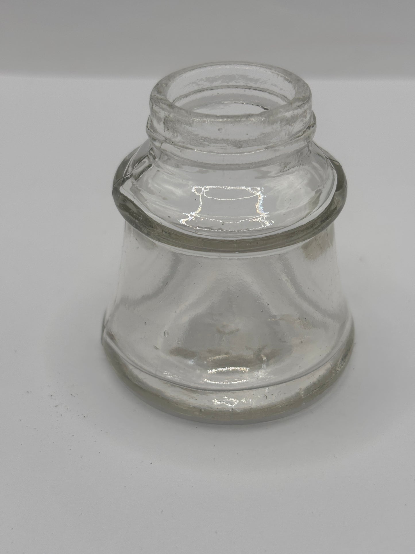 Old clear glass inkwell, ink bottle