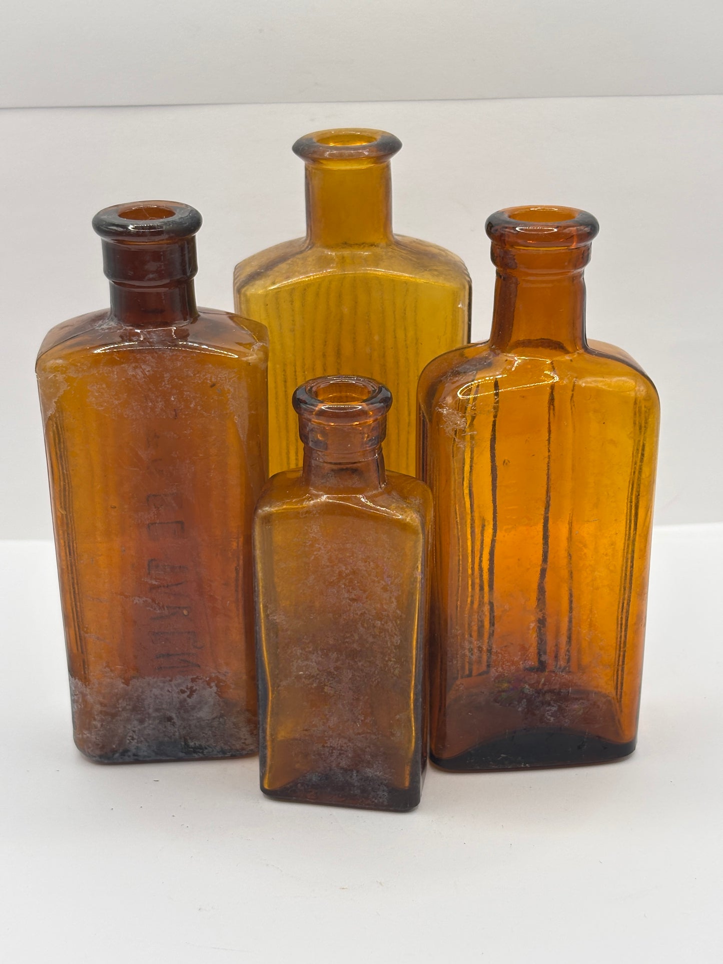 4 crusty Old amber glass poison bottles