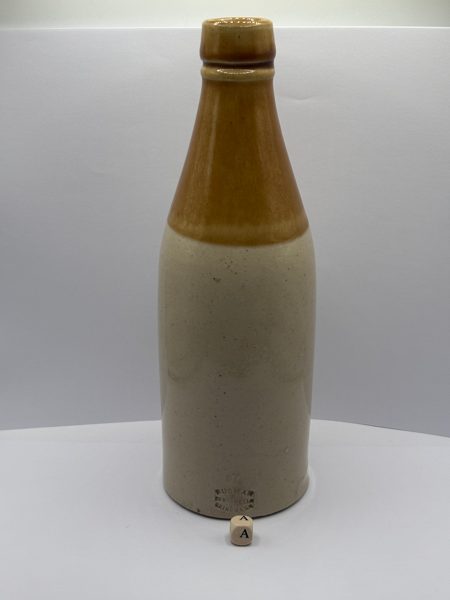 Old plain stoneware ginger beer bottle (a)