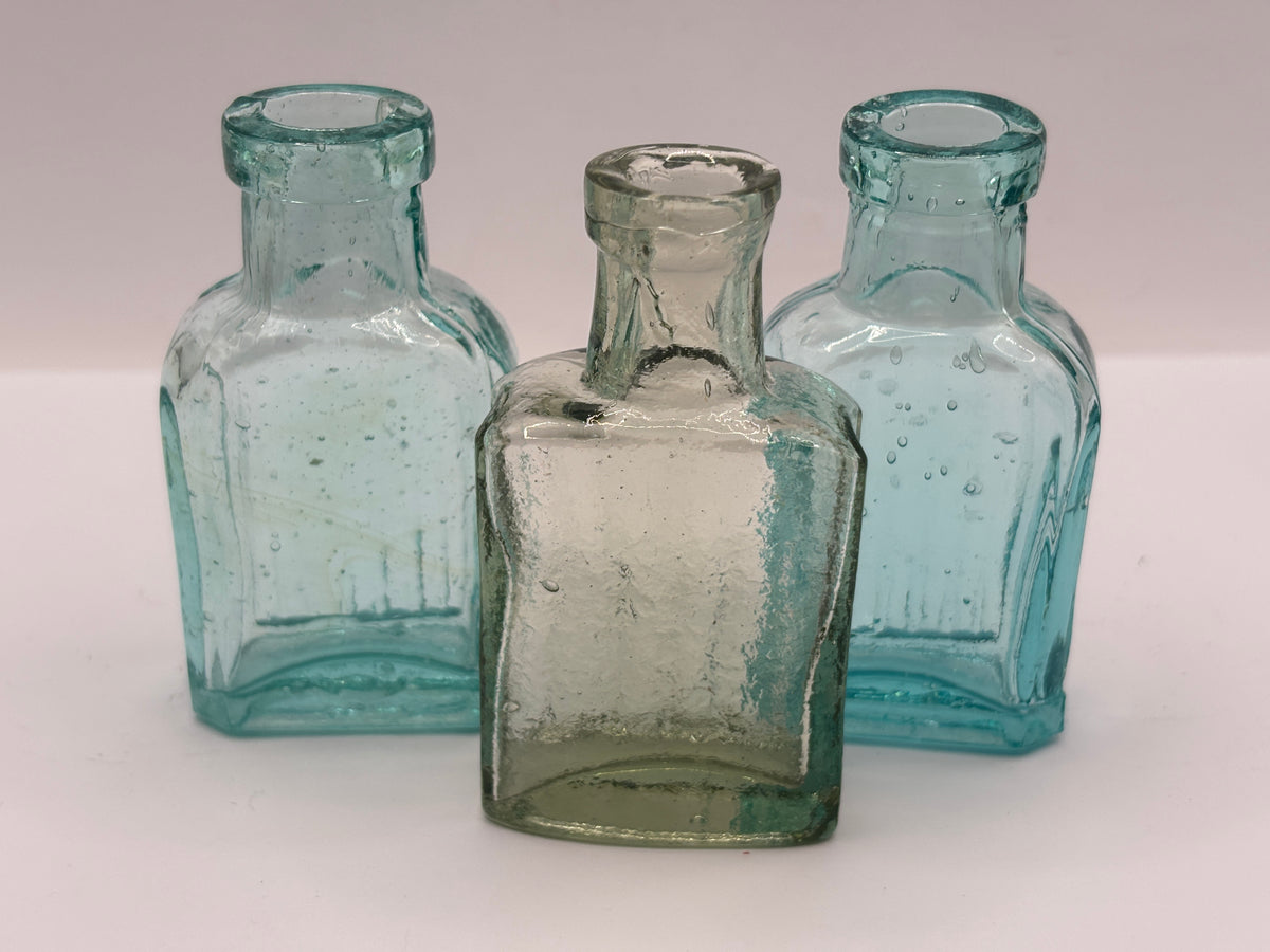 3 small aqua glass bottles