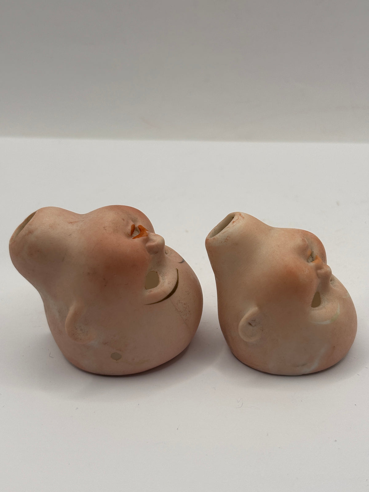 2 Old small bisque dolls heads. Damaged