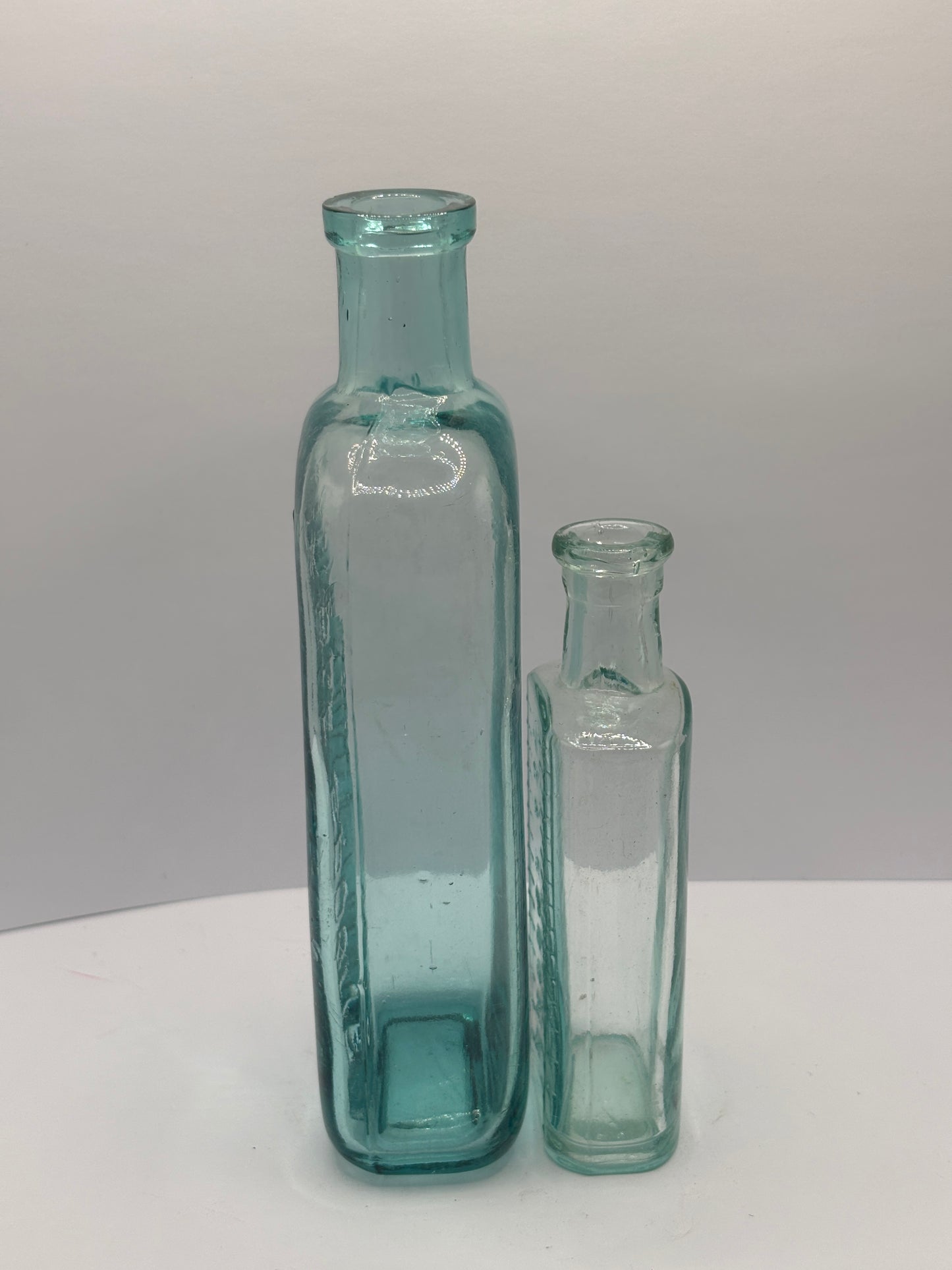 2 old aqua glass tablespoon & teaspoon bottles
