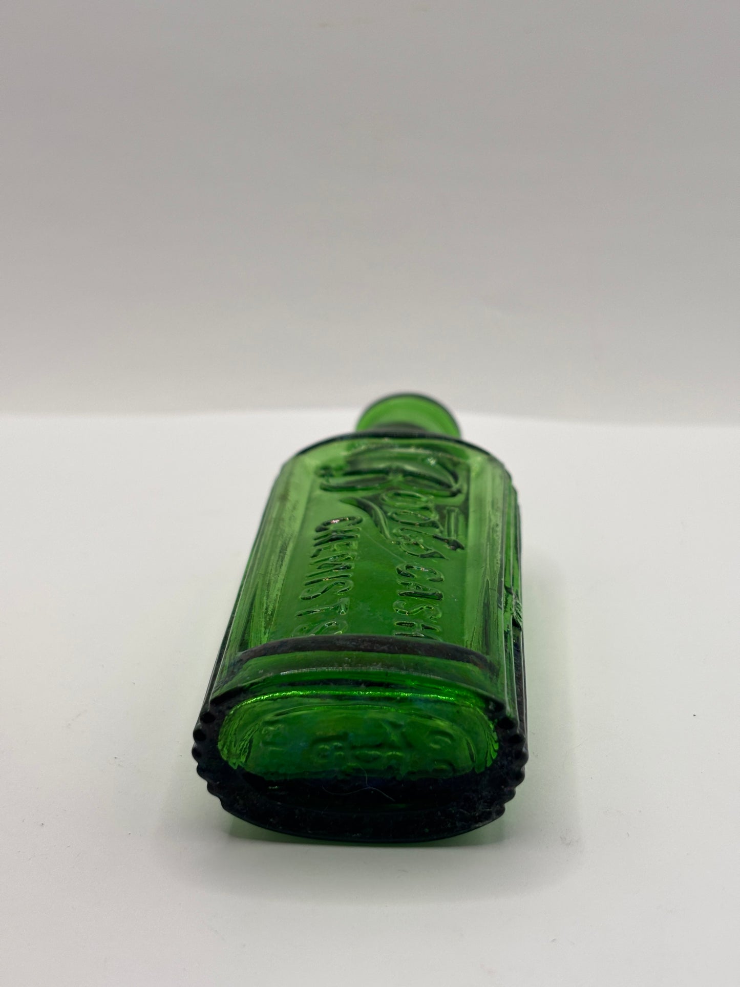 Old green glass advertising bottle. Boots Cash Chemists