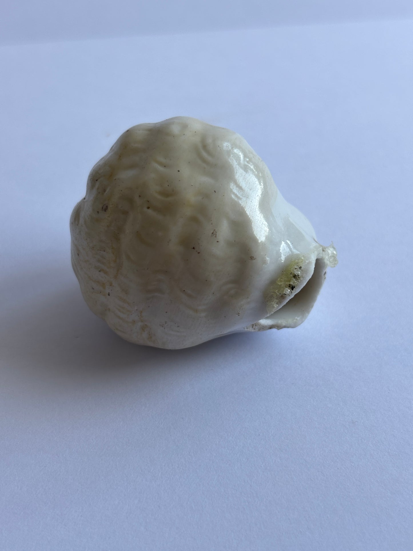 Old small damaged dolls head