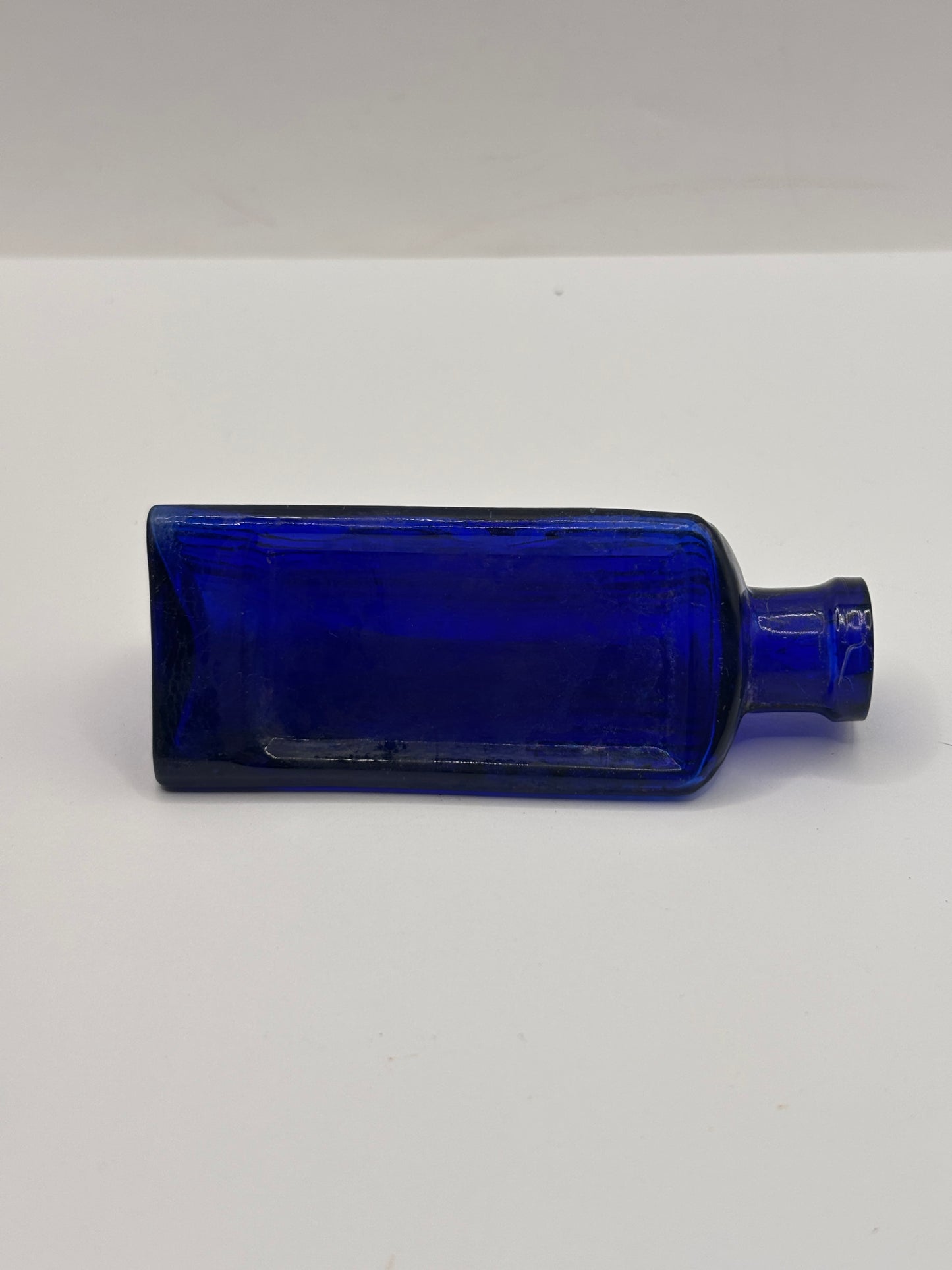 Old small blue triangular poison bottle