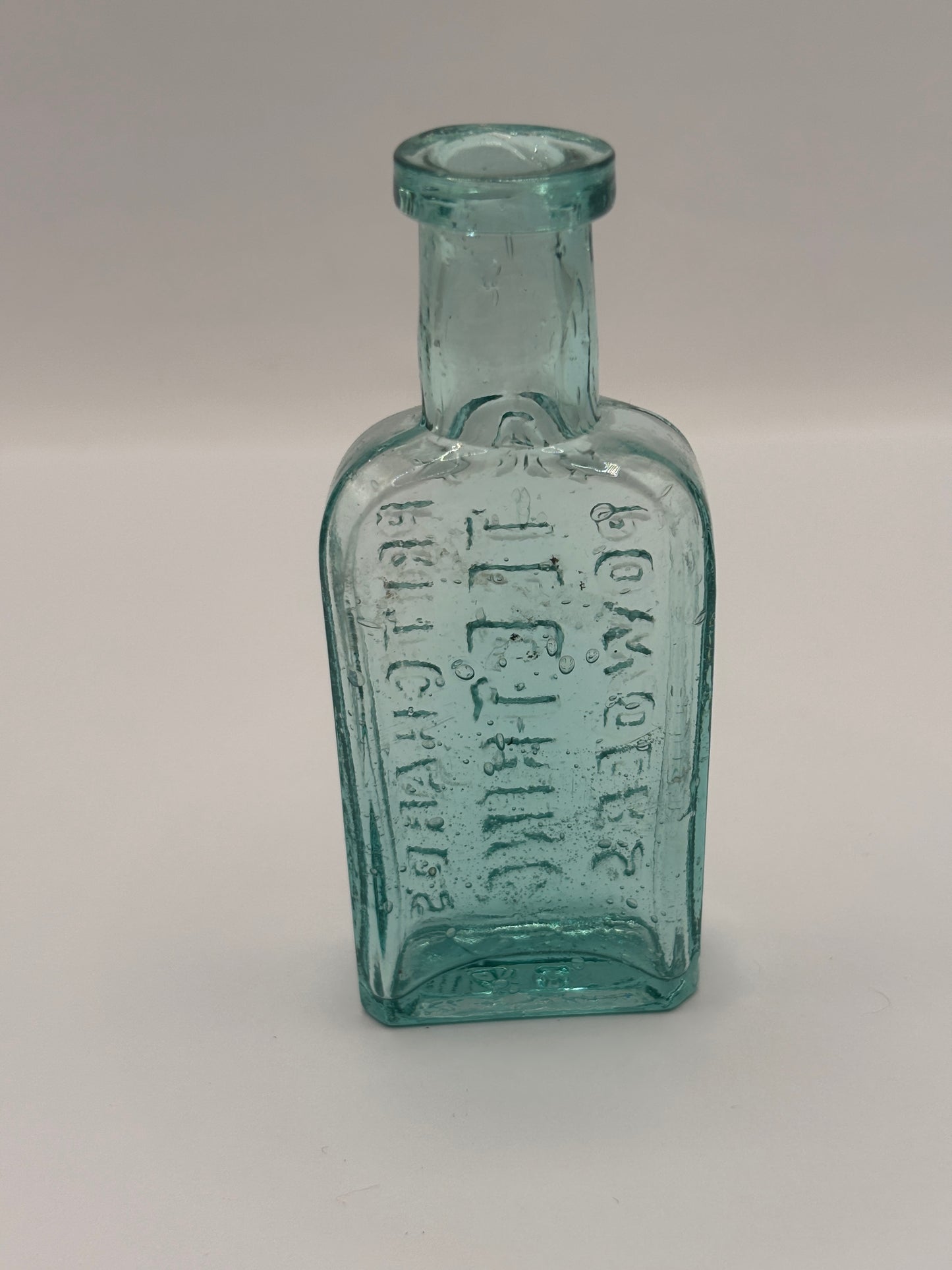 Old small aqua glass advertising bottle. Pritchards teething powders