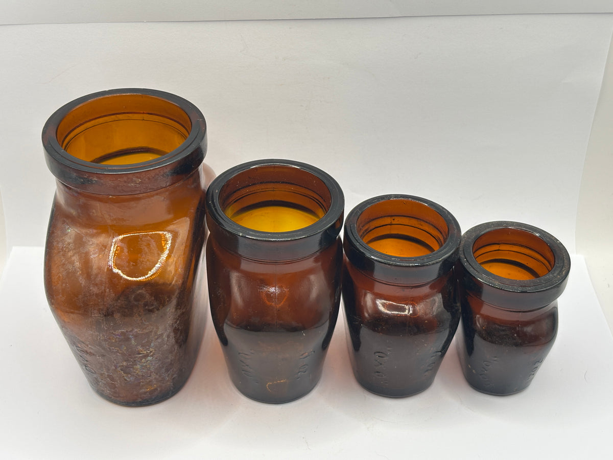 Set of 4 old amber glass OXO bottles. 16oz- 2oz