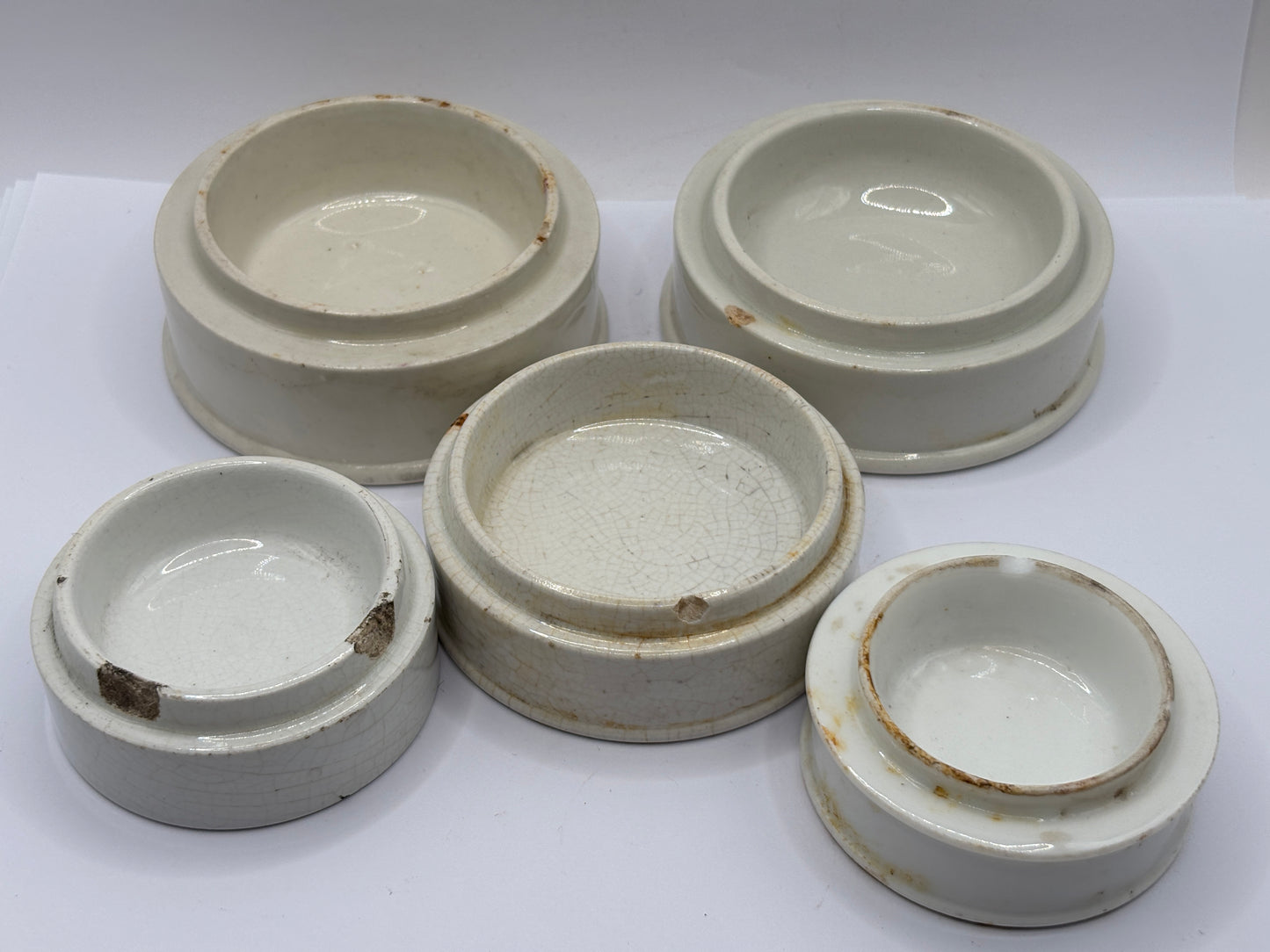 5 plain stoneware bases, stackers. Chipped