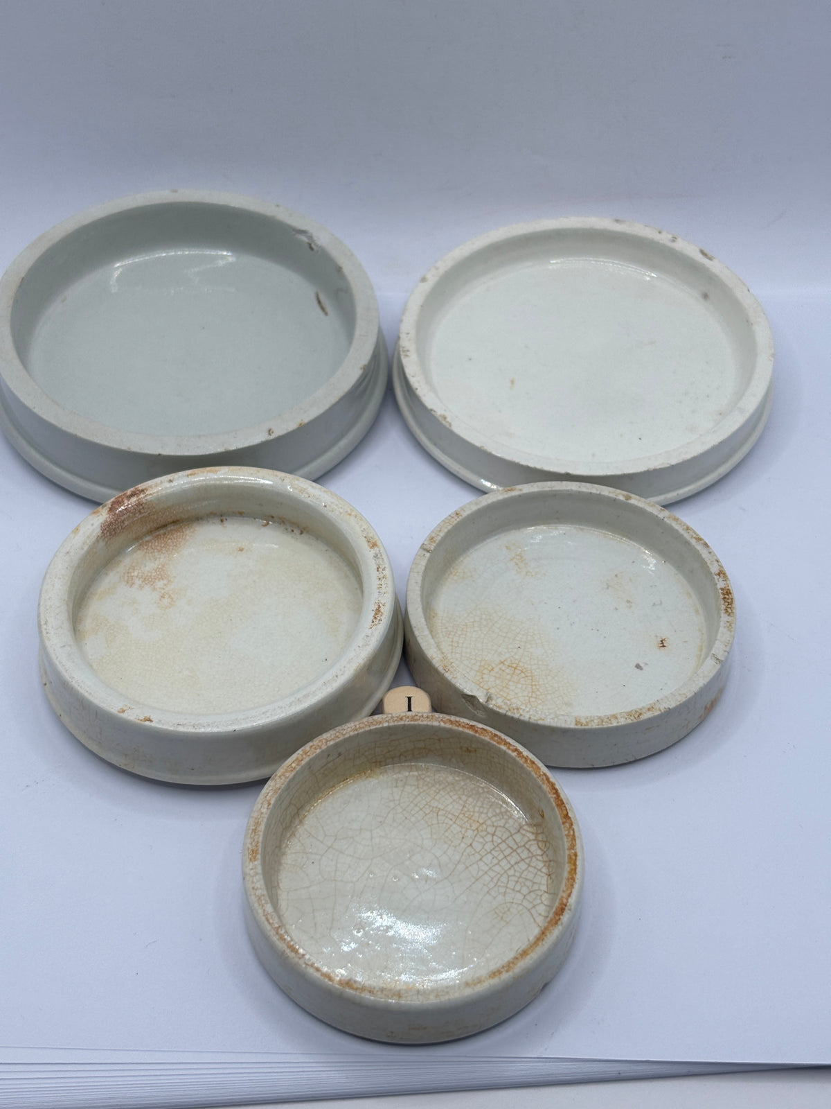 5 old stoneware lids, stackers (i)