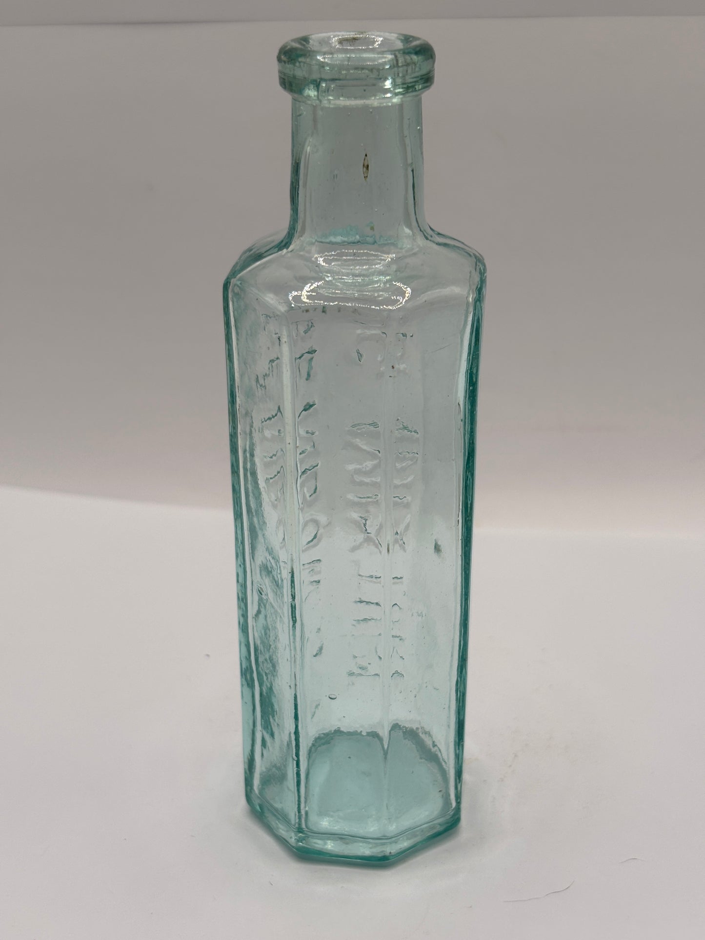Old aqua glass advertising bottle. Benbows dog mixture