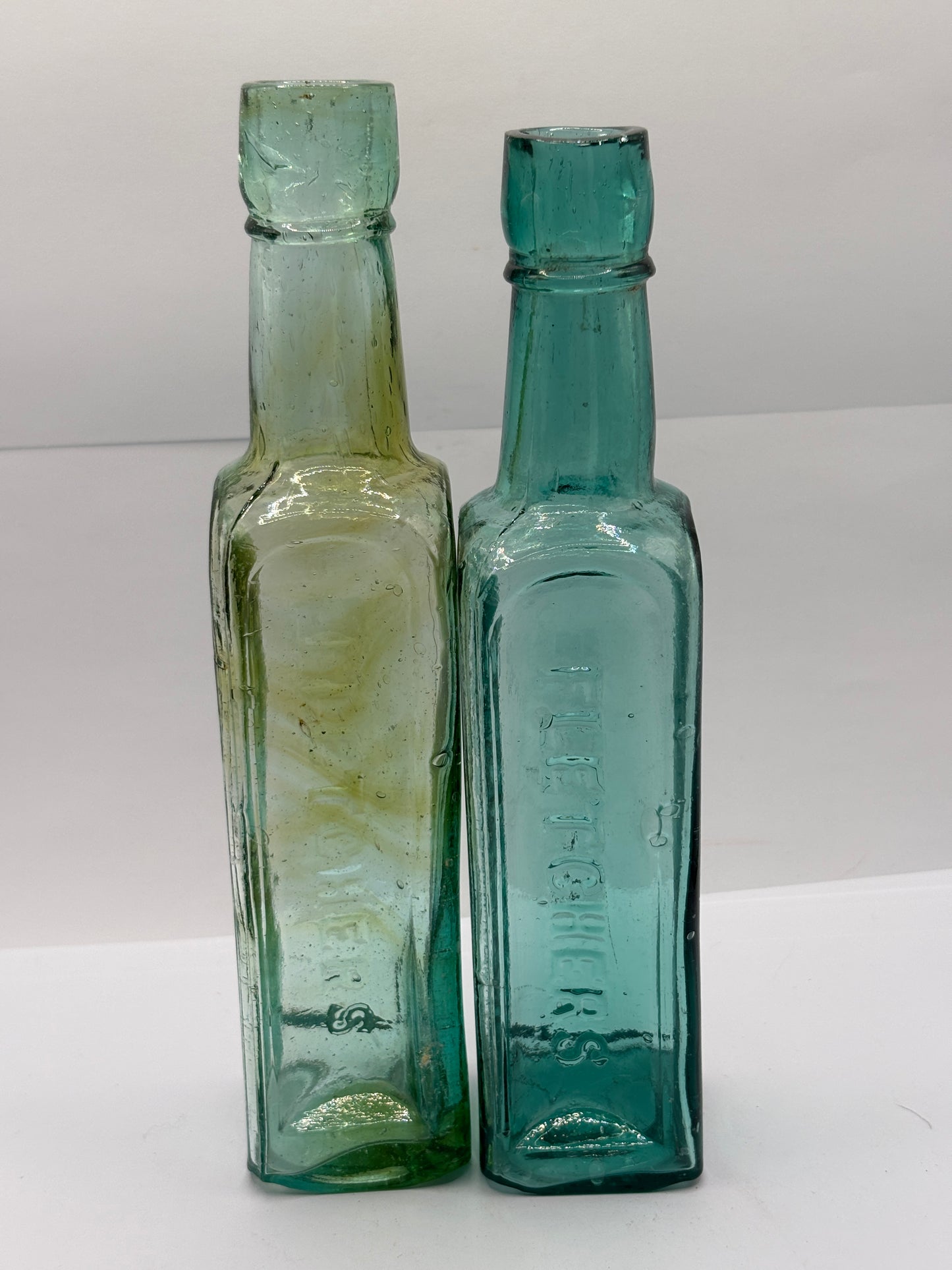 2 old aqua glass sauce bottles, Fletcher’s tiger sauce