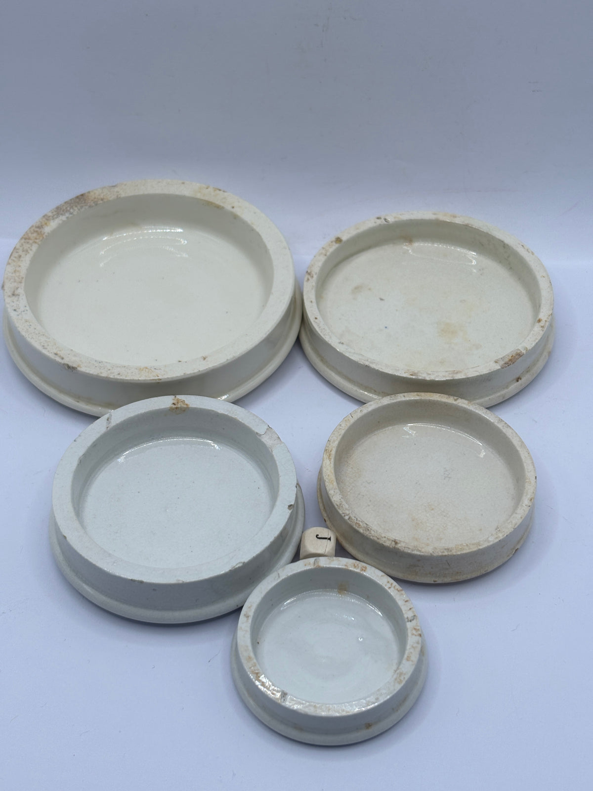 5 old stoneware lids, stackers (J)