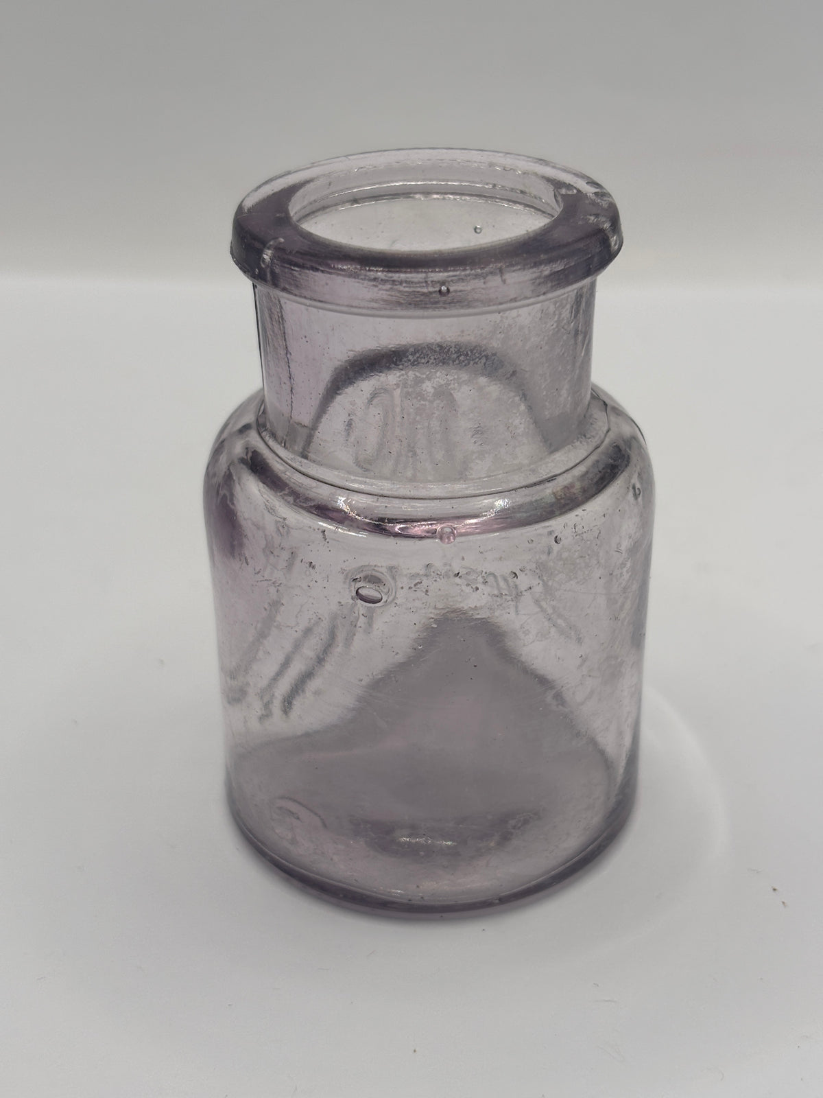Old crusty purple glass vaseline jar