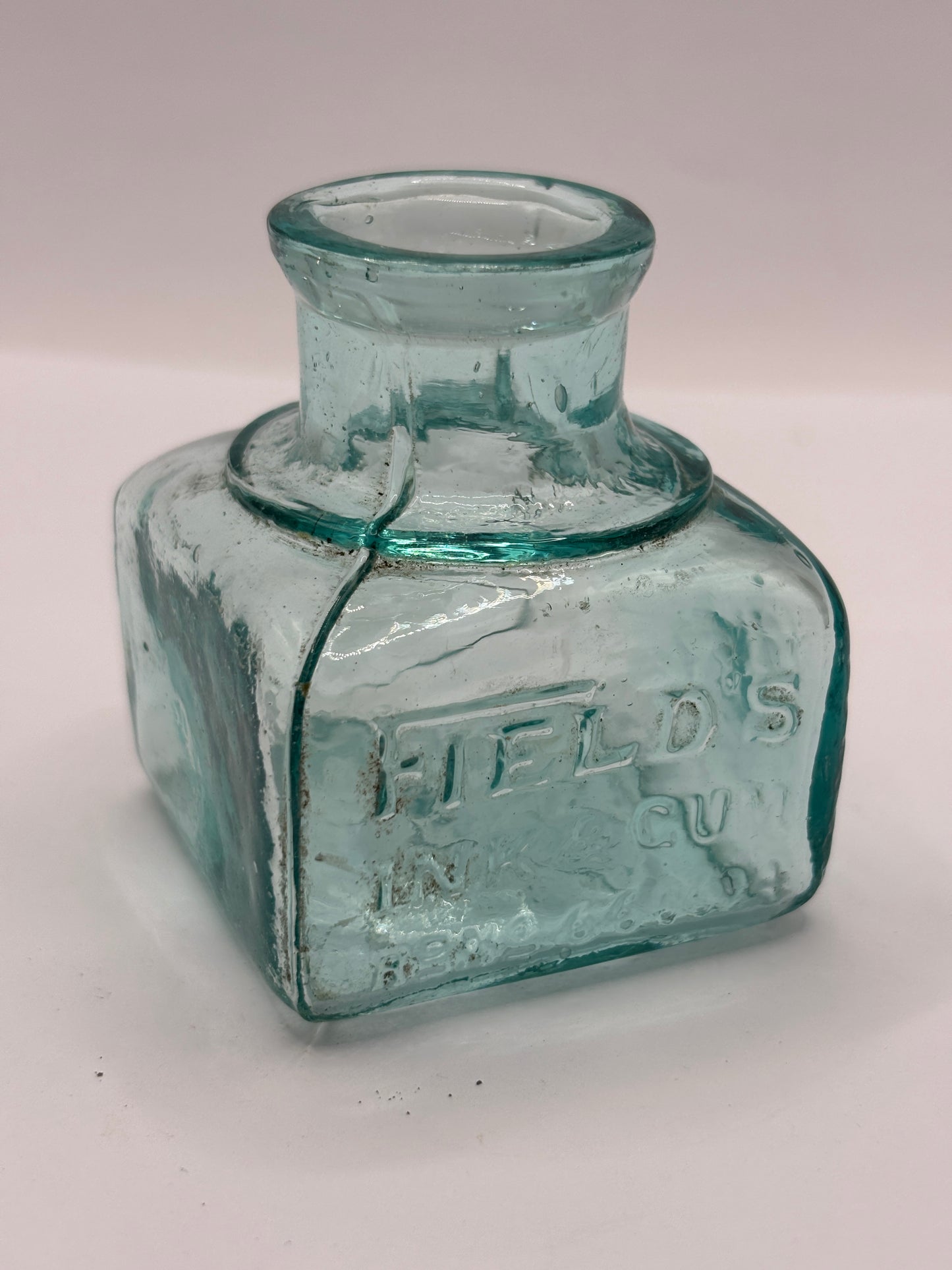 Old aqua glass advertising inkwell, ink bottle. Fields ink