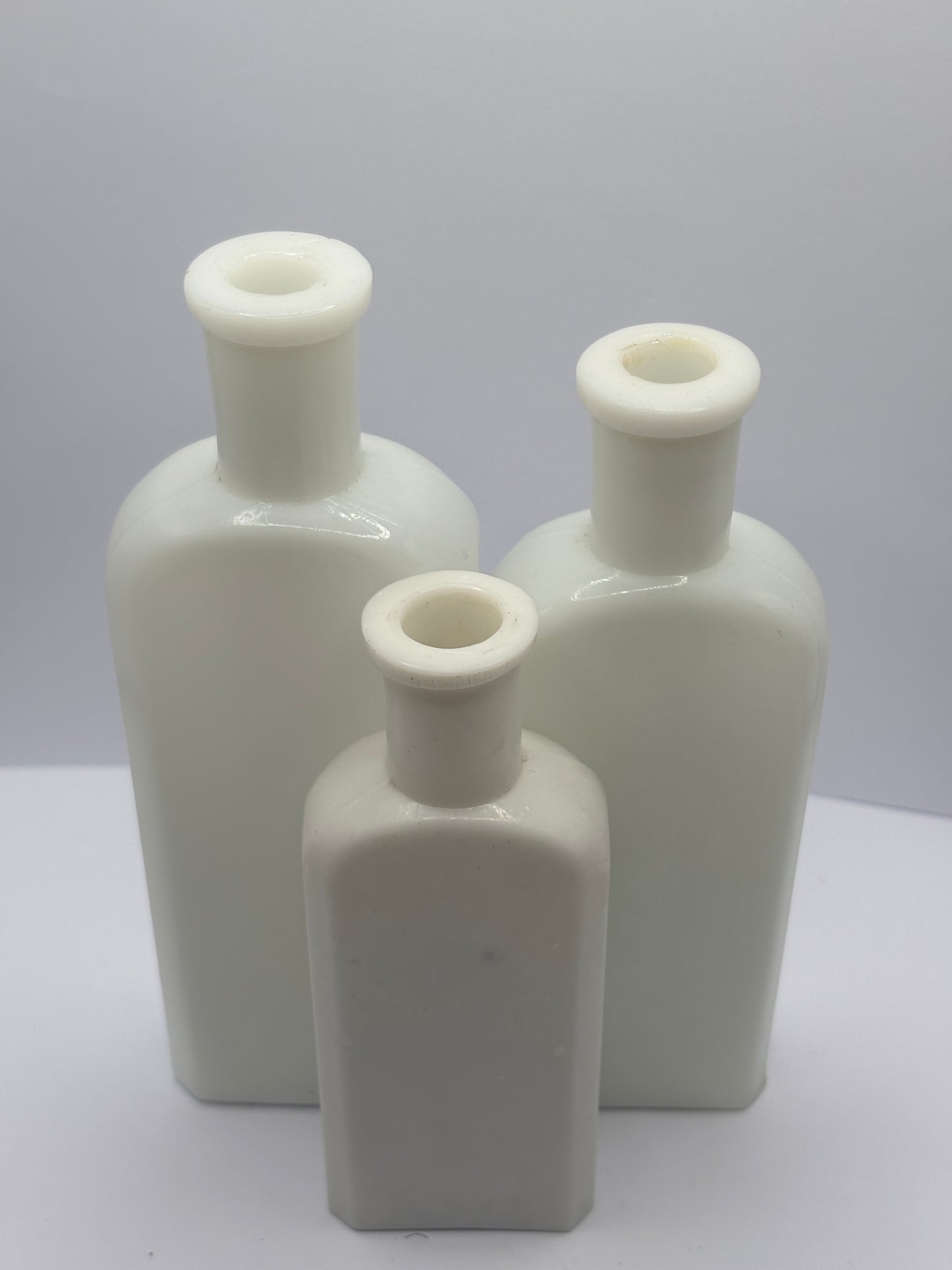 3 old white milk glass bottles