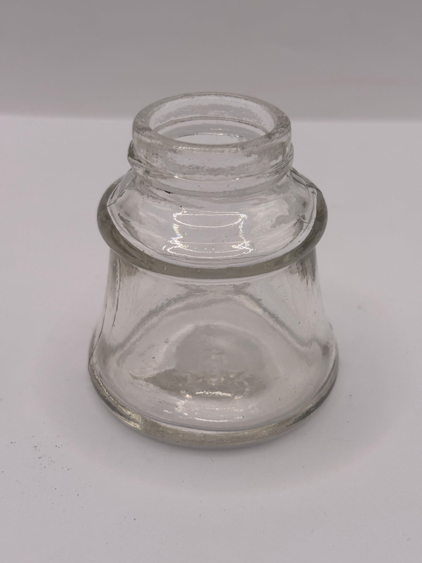 Old clear glass inkwell, ink bottle