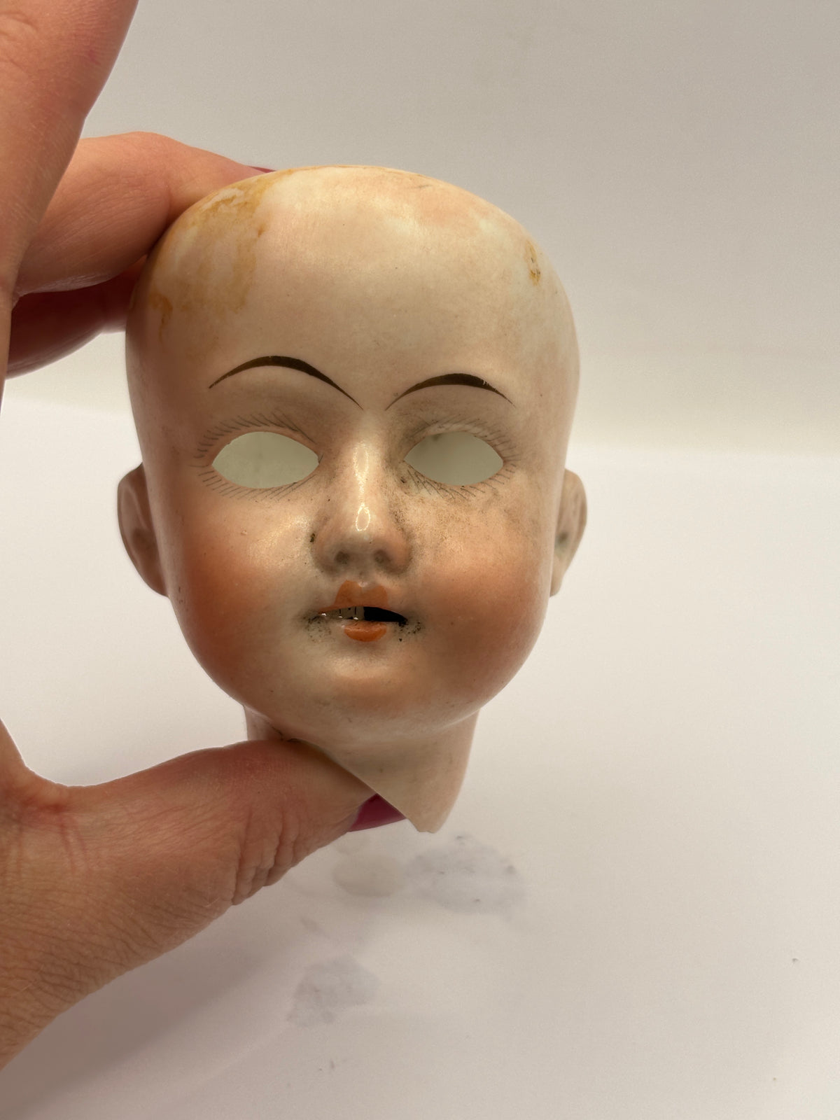 Old bisque dolls head, damaged