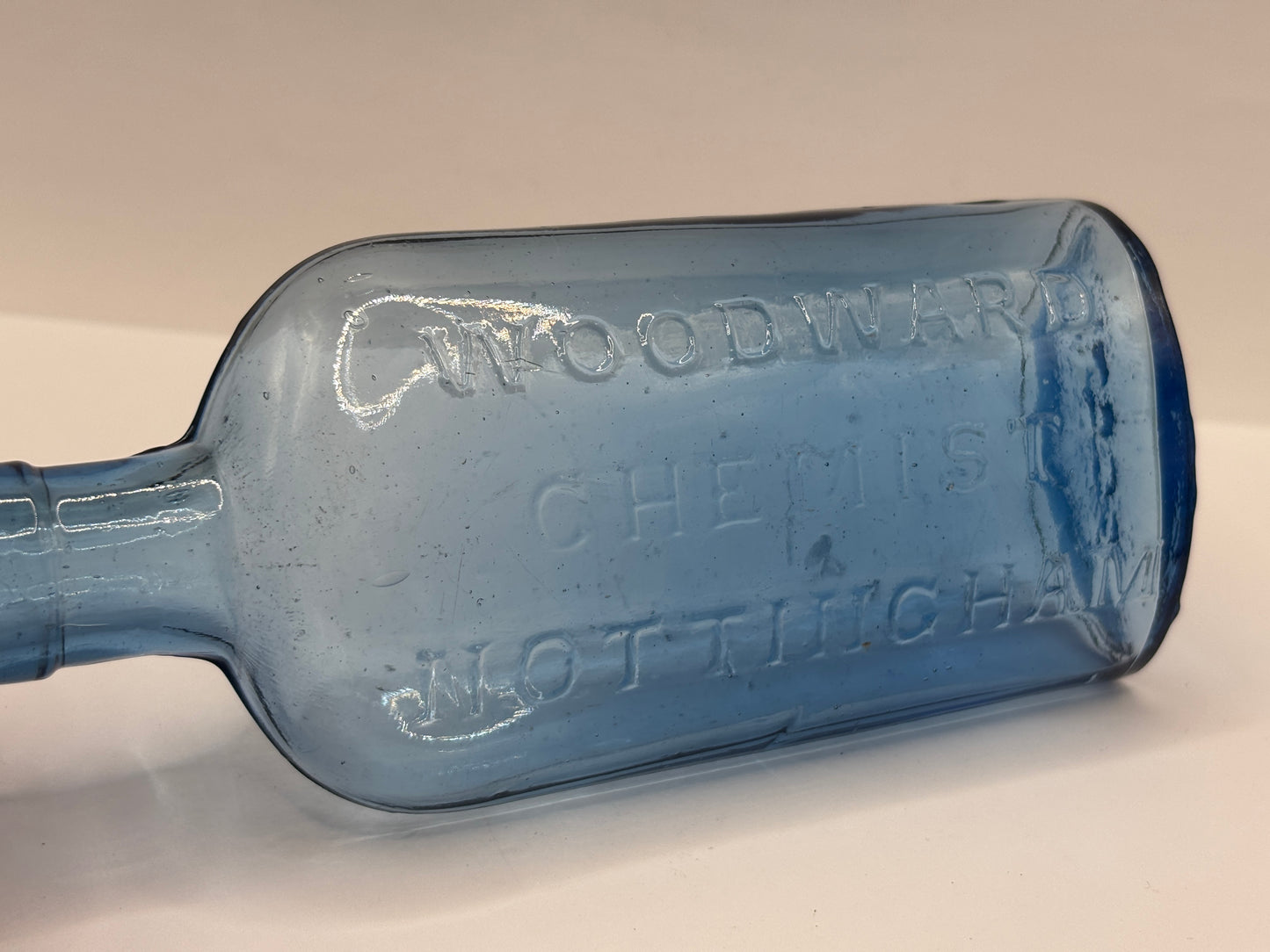 Old blue glass advertising chemist bottle, Woodwards Nottingham