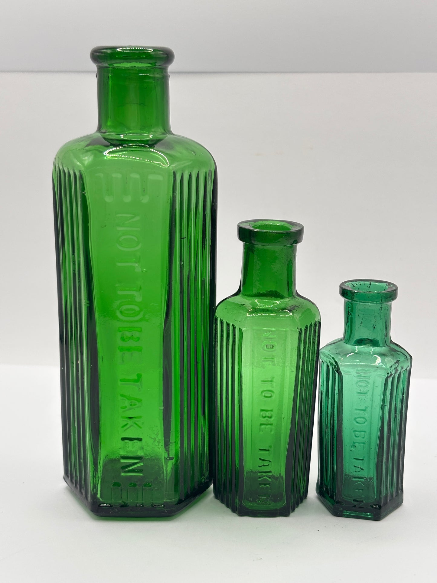 3 Old green glass poison bottles, not to be taken