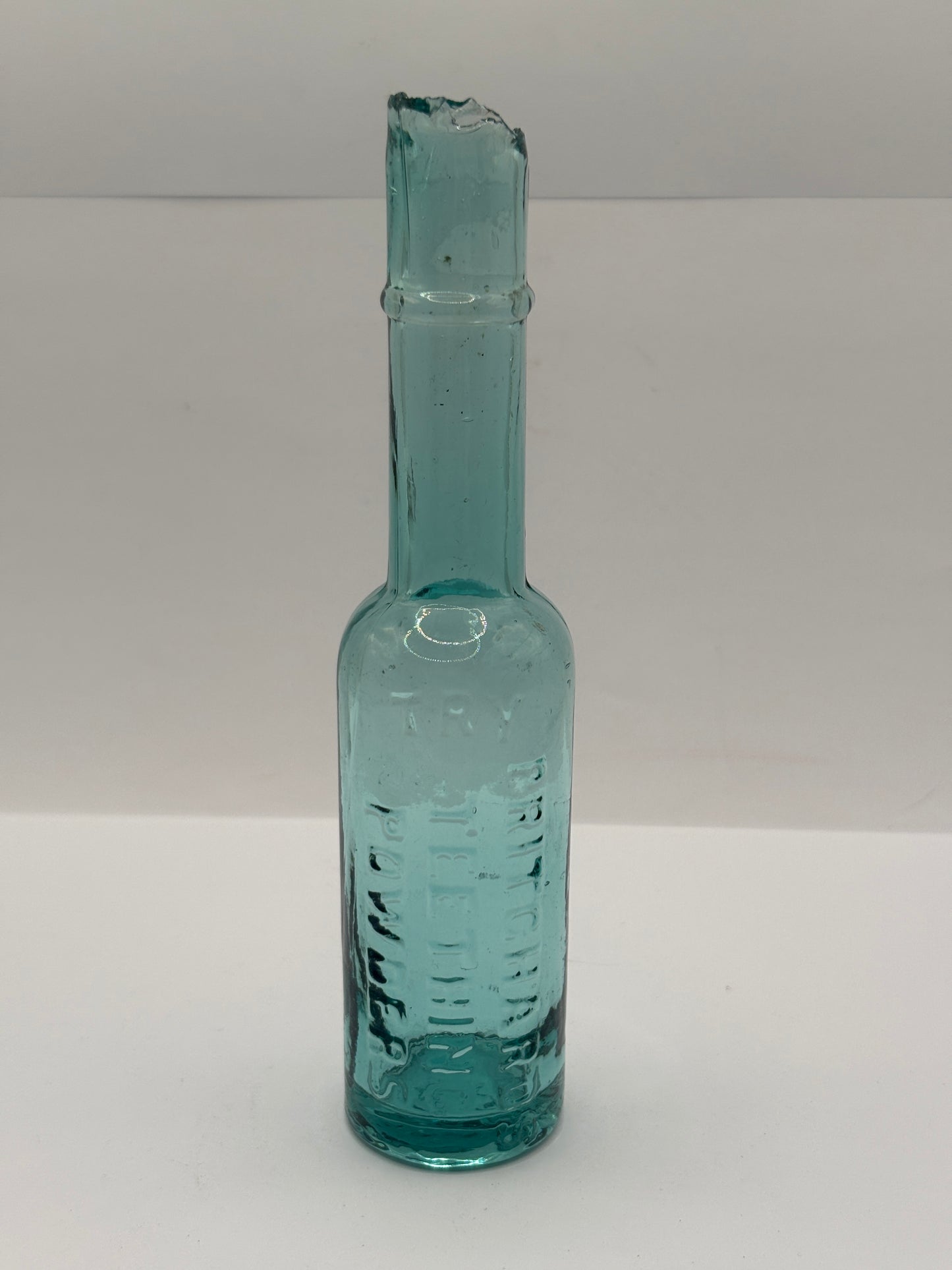 Old aqua glass advertising bottle. Pritchards teething powders