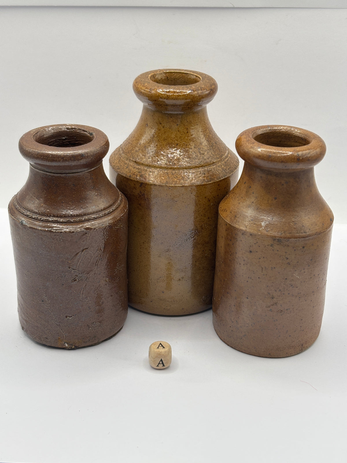 3 tall brown stoneware pots (a)