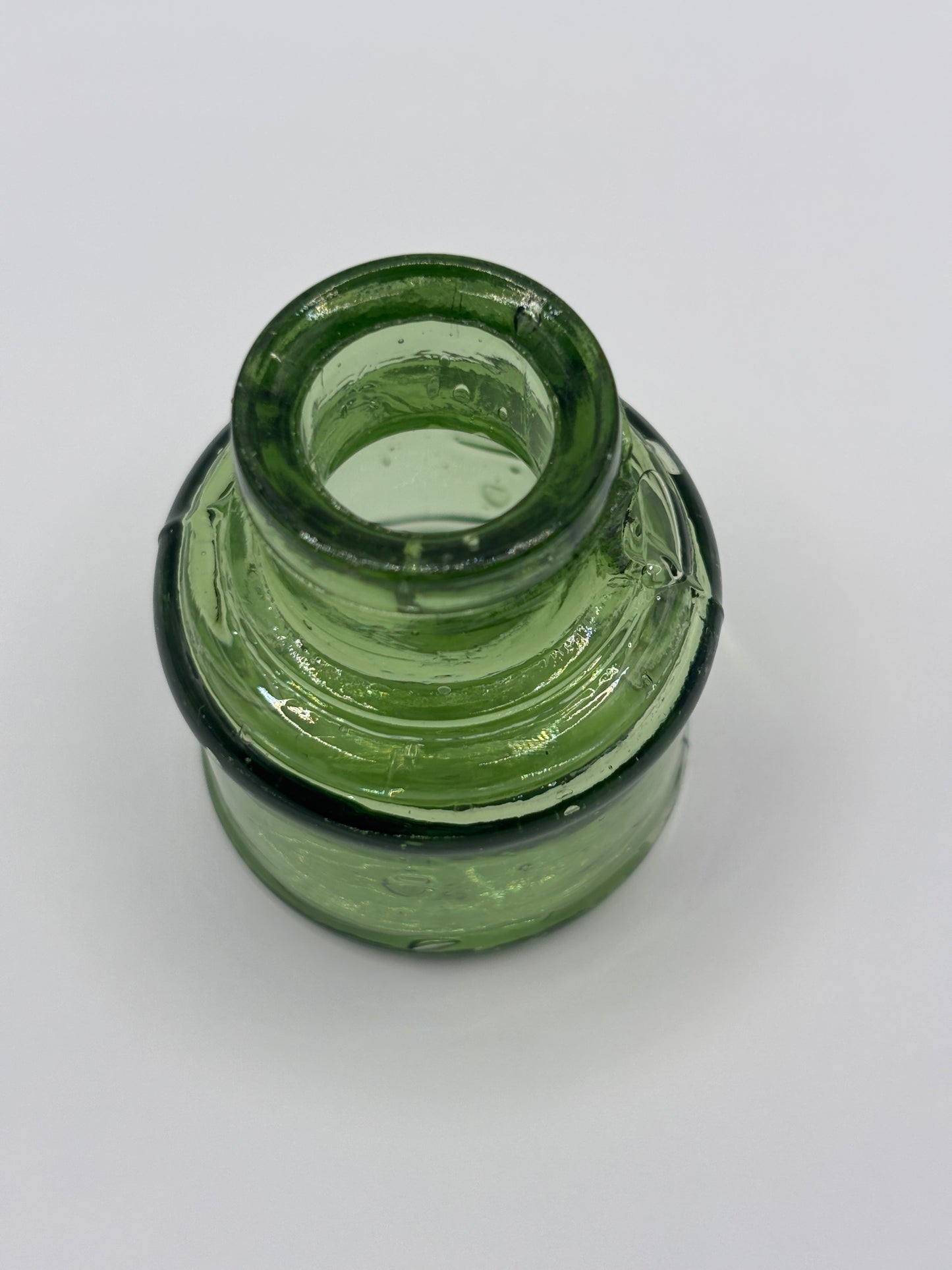 Old green glass ink bottle, inkwell