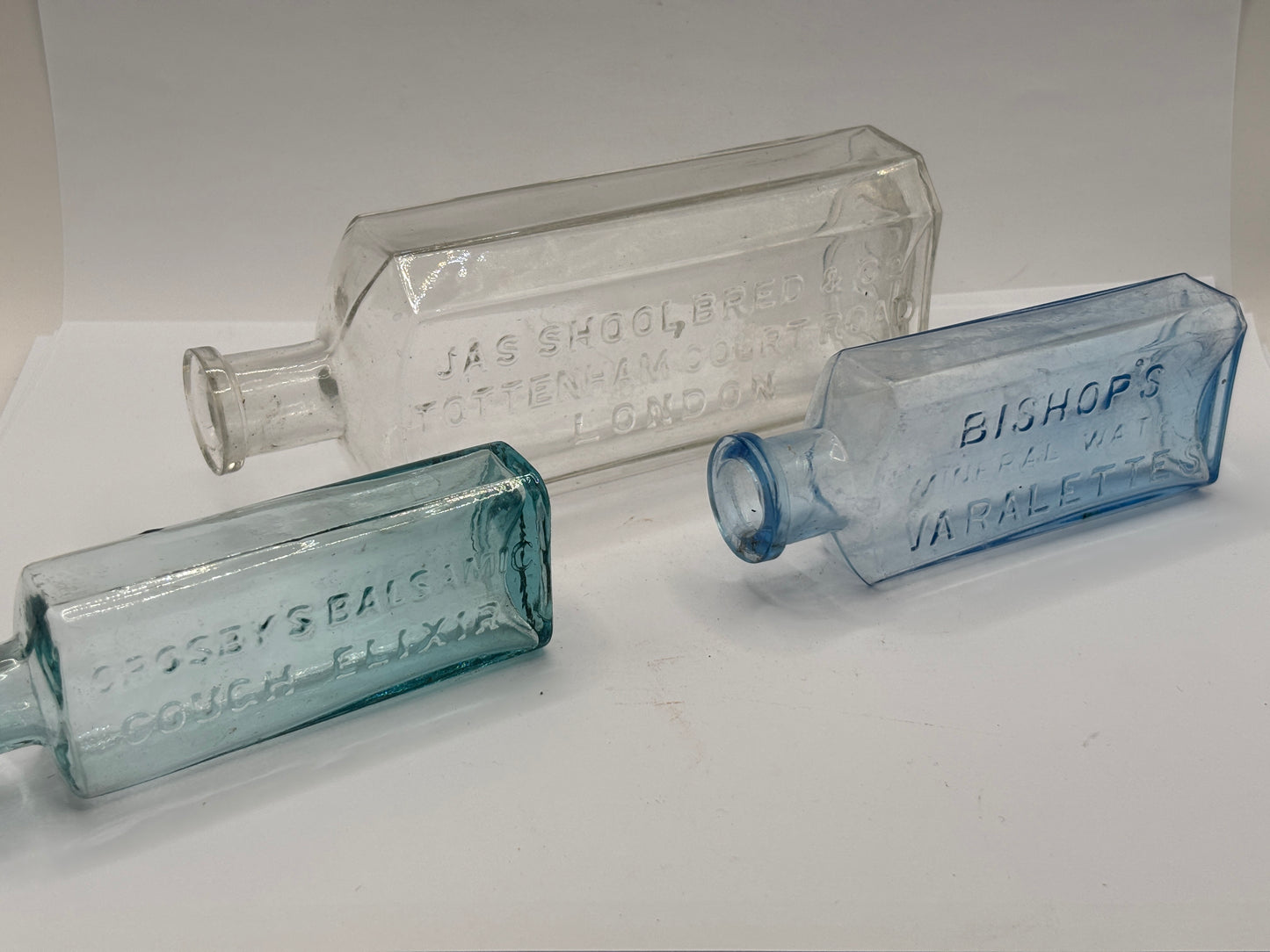3 old glass advertising chemist bottles