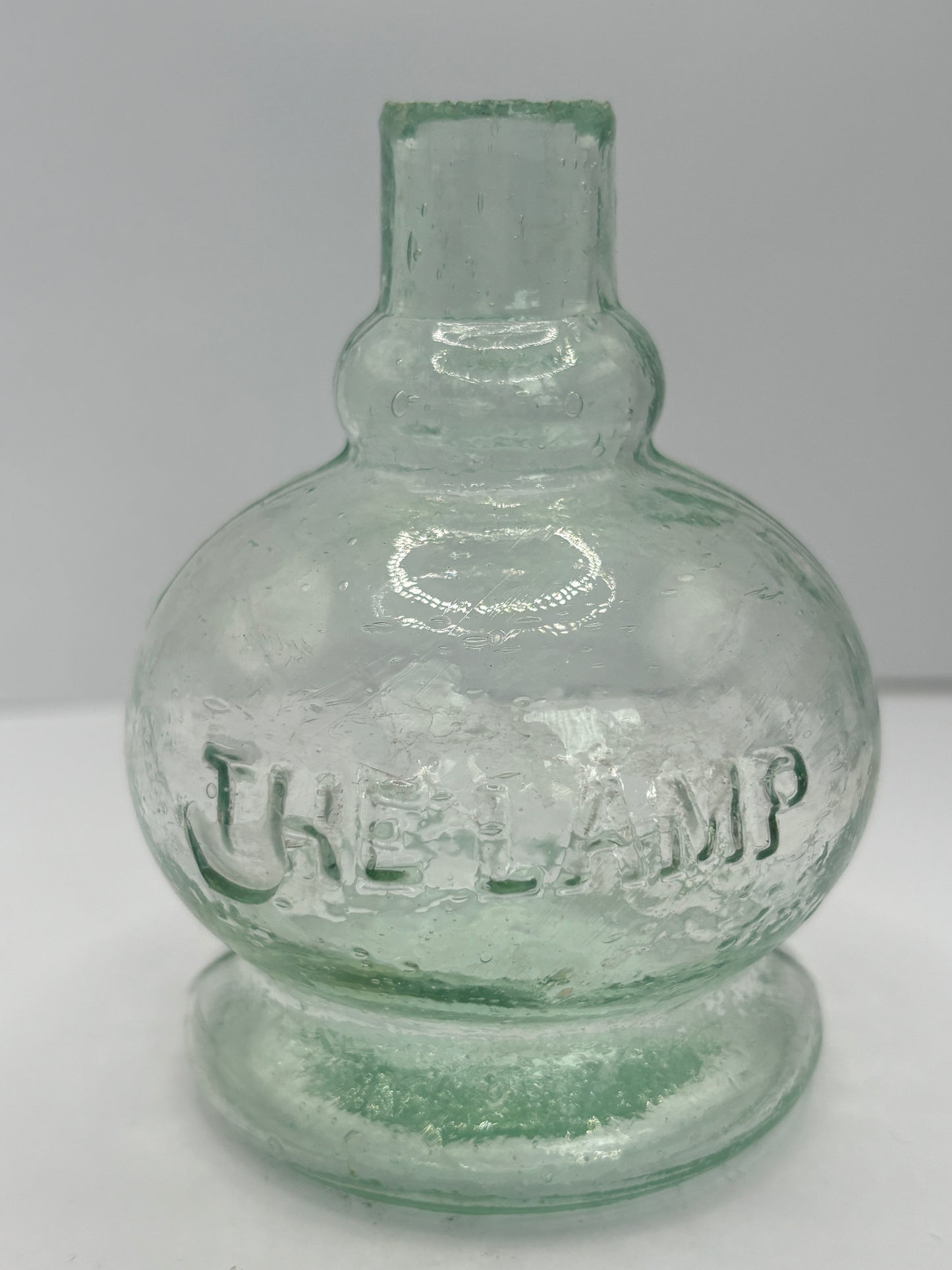 Small aqua glass oil lamp. The Lamp