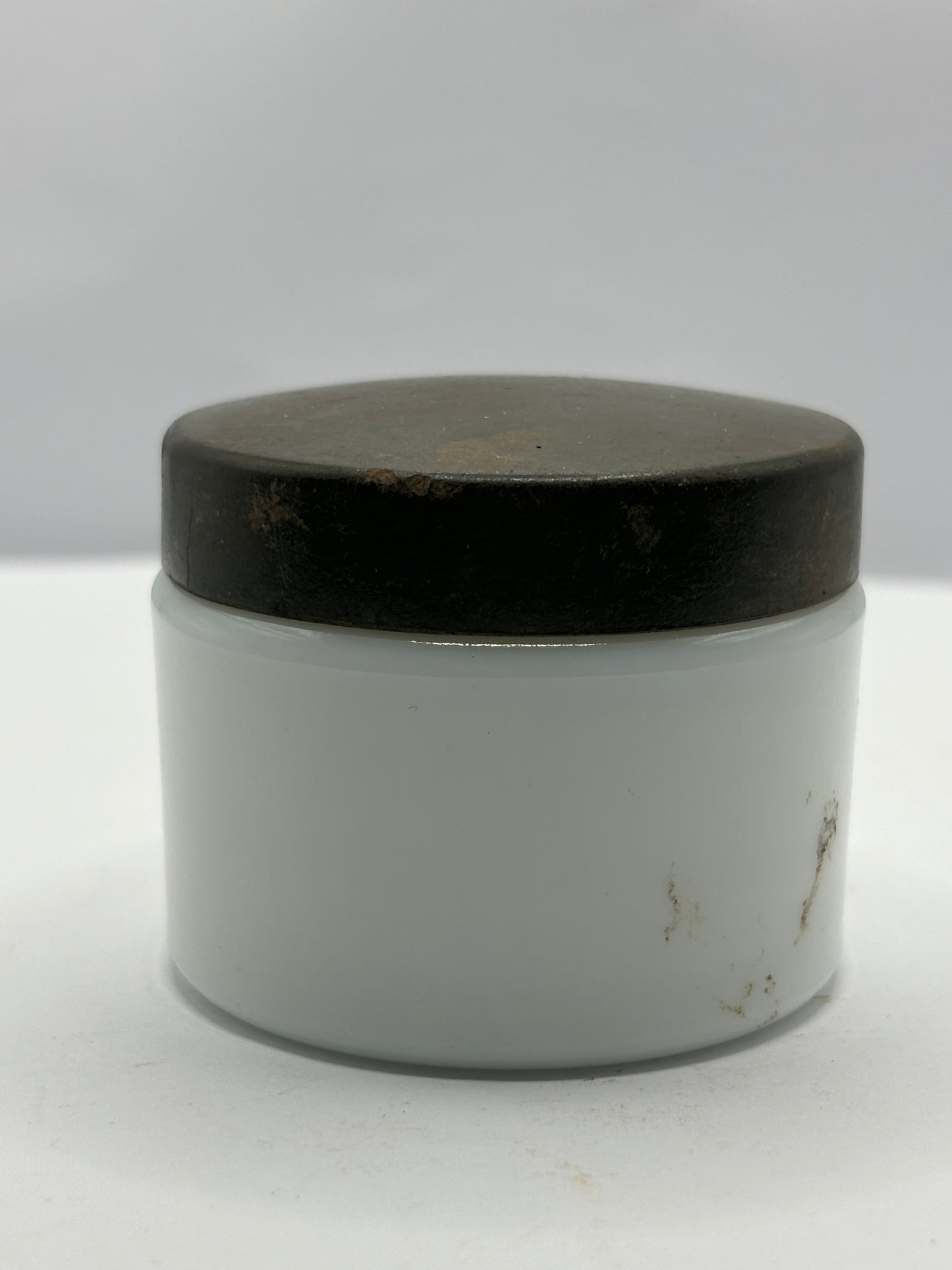 Small milk glass jar with original lid