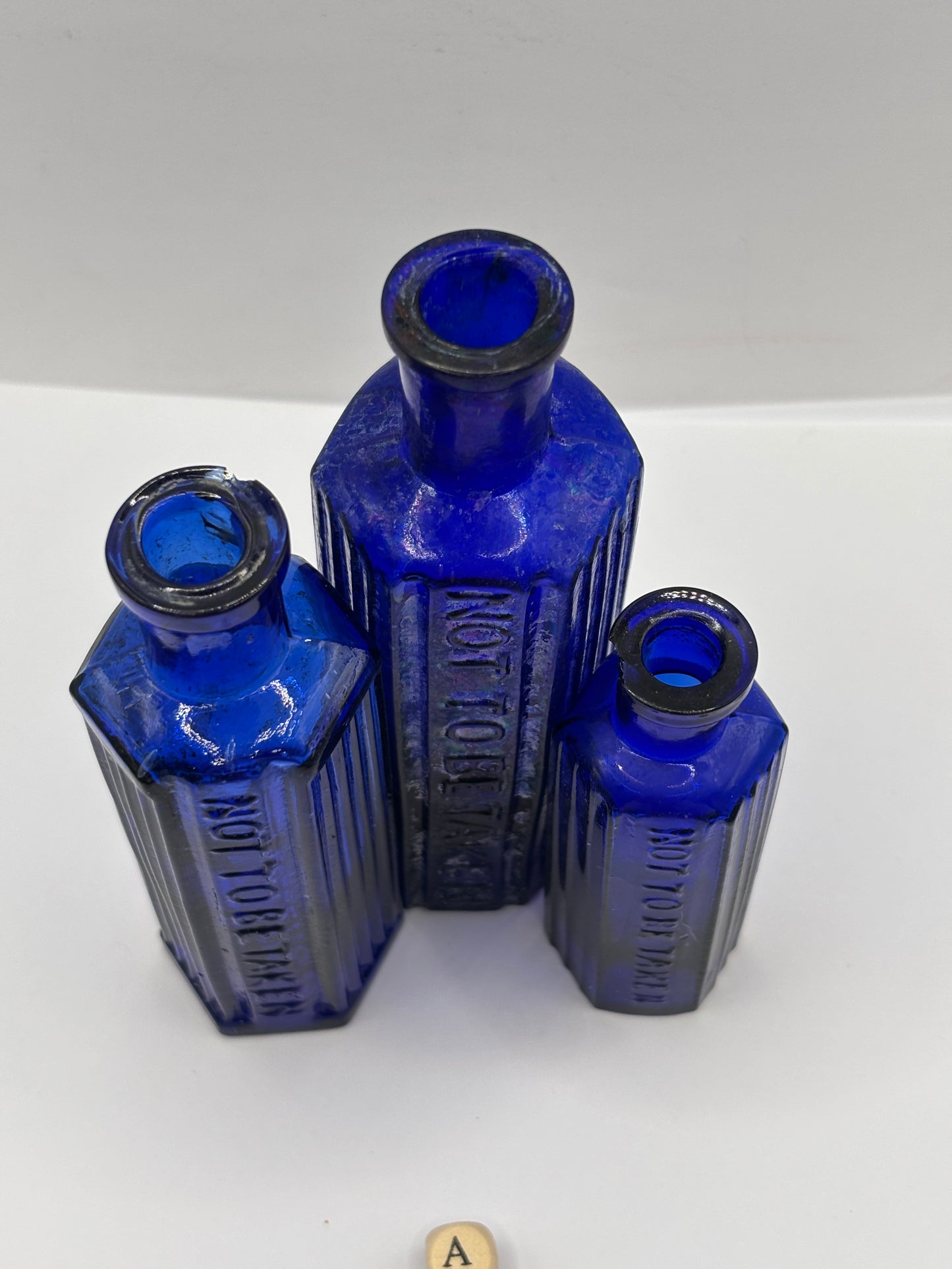 3 old blue glass poison bottles, chipped & crusty (a)