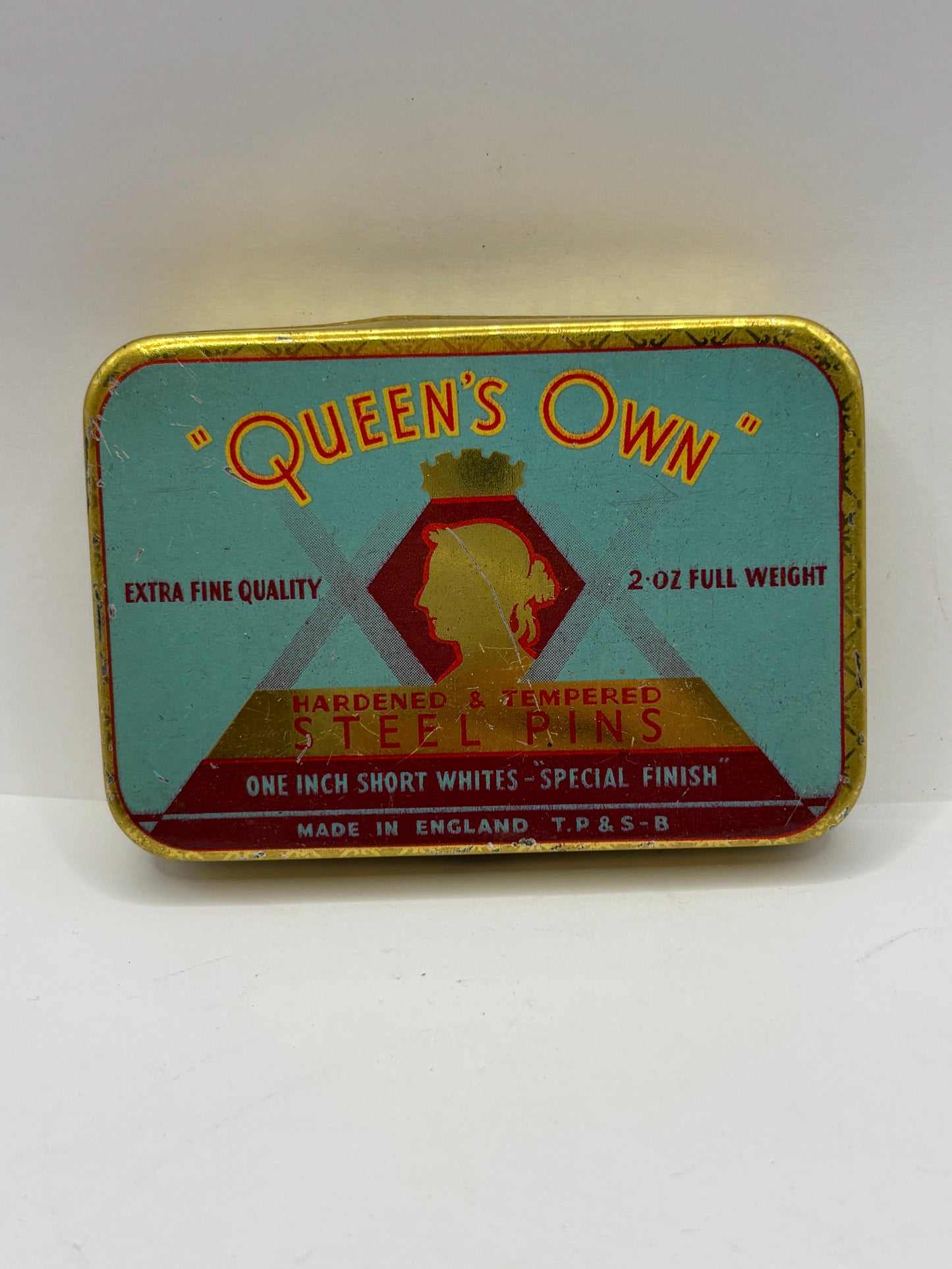 Old advertising tin, Queens own steel pins