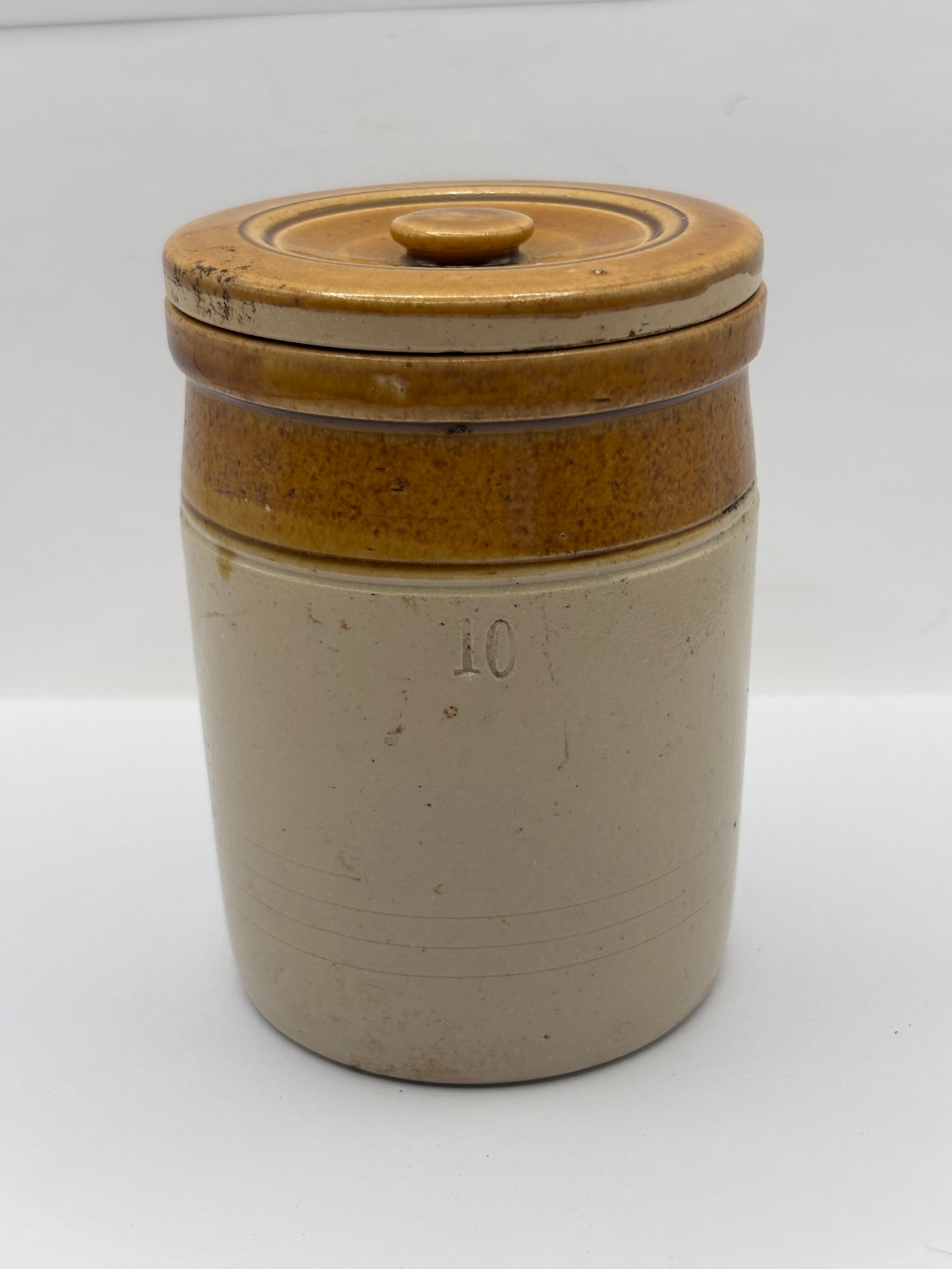 Old brown top stoneware jar and lid