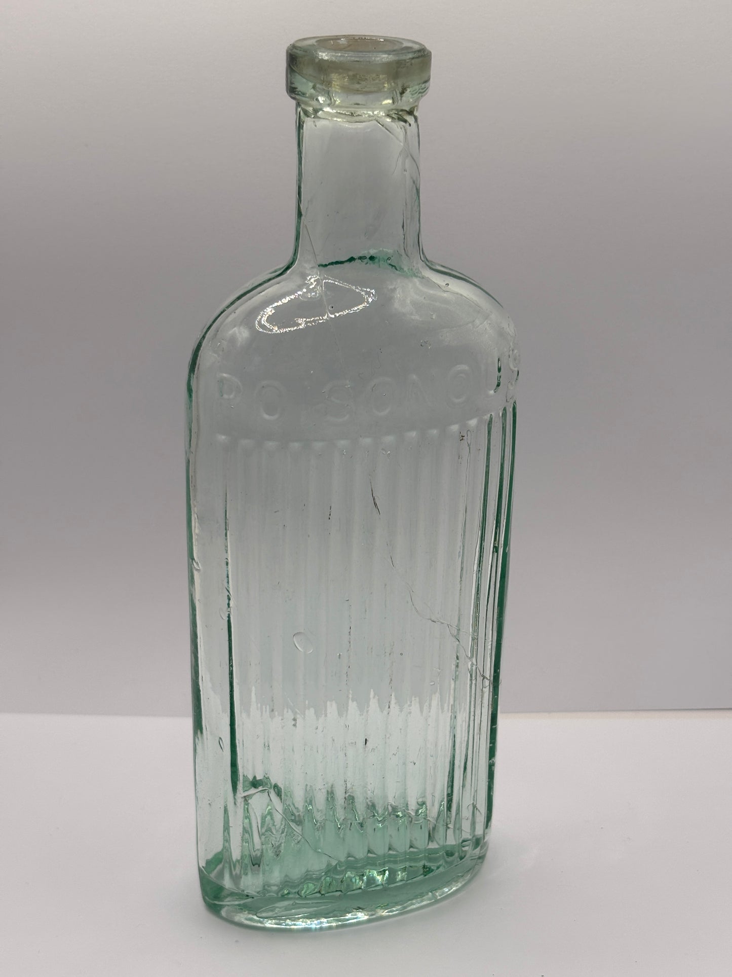 Old aqua glass poison bottle, Poisonous