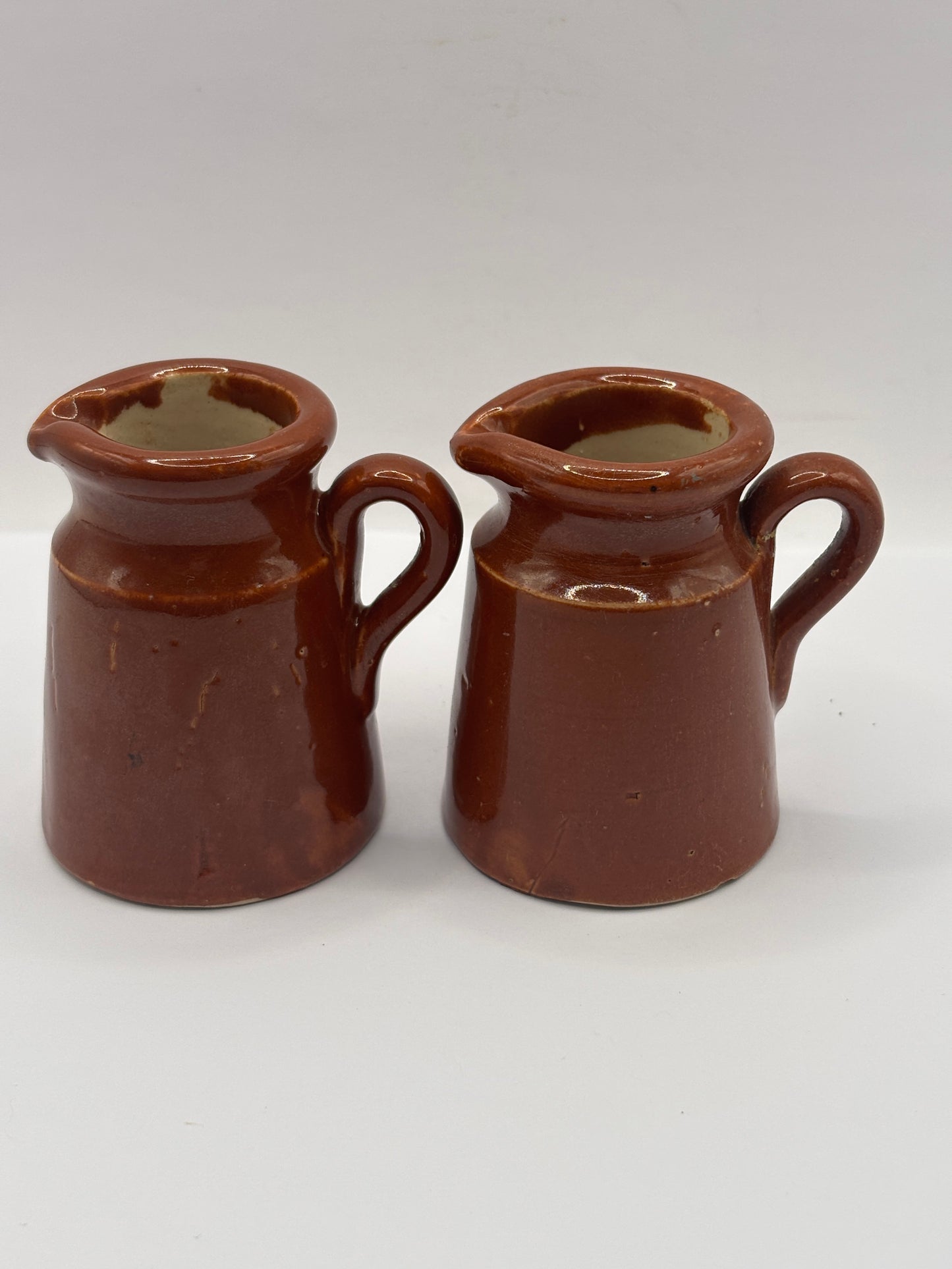 2 old small brown stoneware cream pots, pouring cream