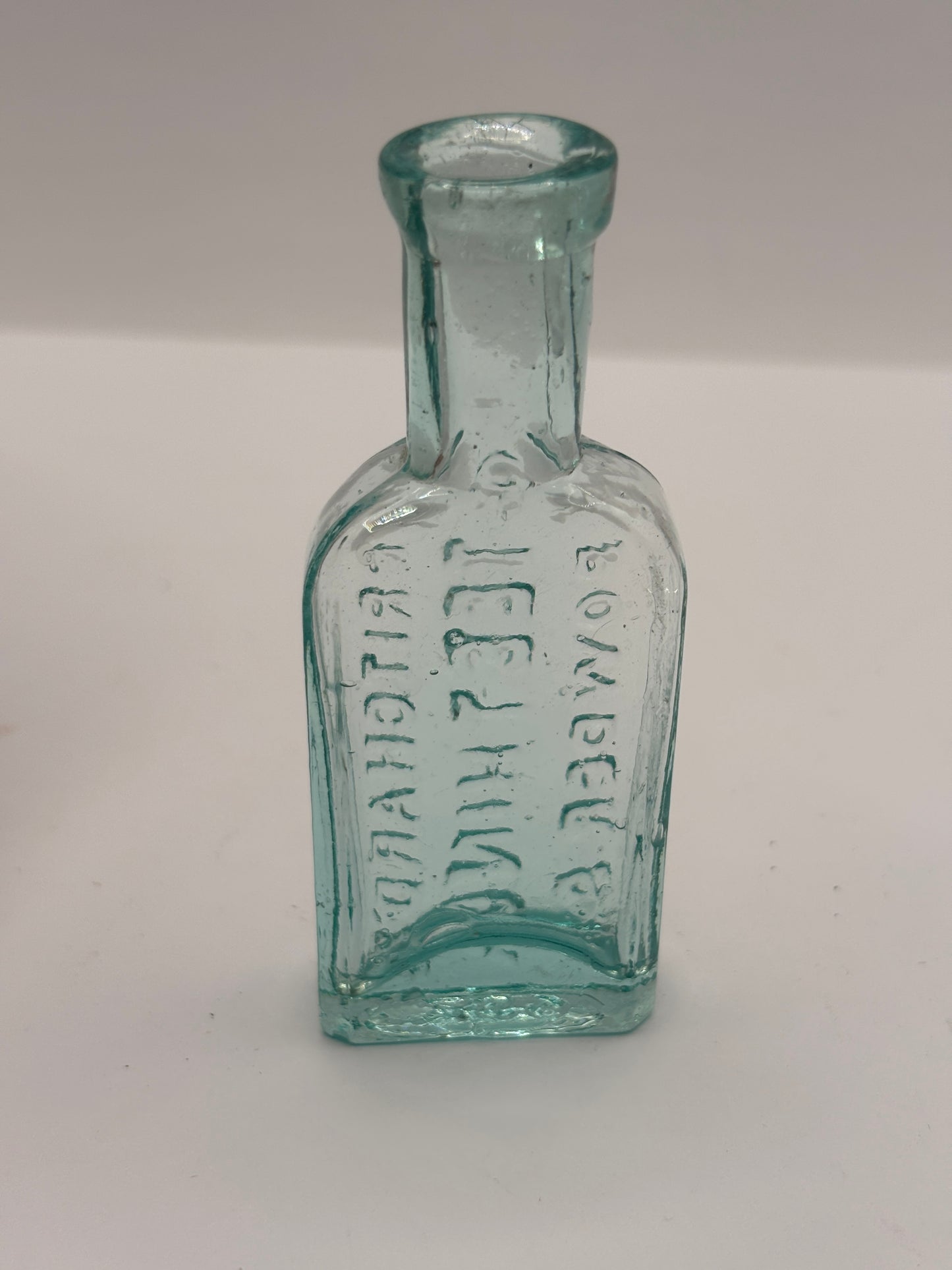 Old small aqua glass advertising bottle. Pritchards teething powders