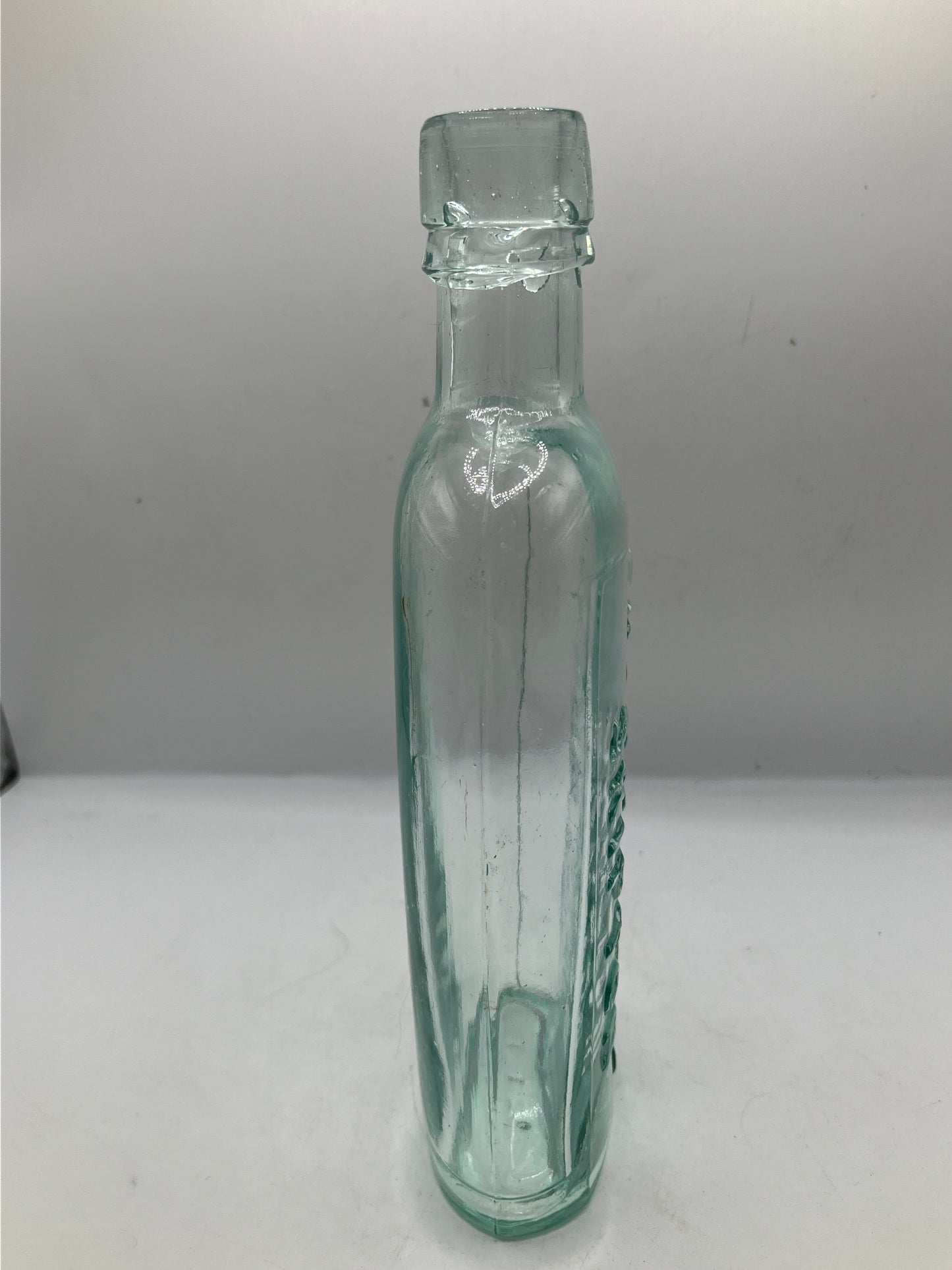 Aqua glass advertising spirit flask, Skipton